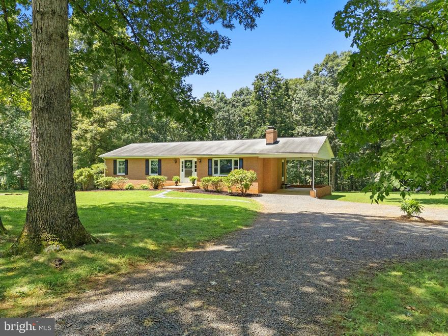 Meticulously maintained 3BD/2BA full-brick rambler on a beautiful 2-acre park-like lot, offering privacy and peace, just minutes from Warrenton, shopping, restaurants, medical care, and major commuter routes (28, 29 & 17)! Work from home with Xfinity high-speed internet connectivity! Turn into your driveway to find ample parking, a covered carport, and a welcoming walkway leading to a freshly painted front door with storm door and matching shutters (July ’25). Step inside to an inviting Foyer that opens into the spacious Living Room, perfect for entertaining, featuring like-new, gleaming hardwood floors, and a cozy brick wood-burning fireplace with decorative mantel and blower. The Living Room flows into the Dining Room, which also boasts hardwood floors, a new trendy light (July '25), and an updated sliding glass door that opens to a large deck with maintenance-free decking overlooking the sunlit backyard framed by mature trees—a serene, park-like retreat! The Chef's Delight Kitchen offers ample cabinets, generous countertop prep area, practical kitchen appliances, a sun-filled Breakfast Nook, and convenient access to the covered carport through a side door with storm door. The Primary Bedroom, generously sized, features a spacious walk-in closet with a built-in closet organization system, plus a Full Ensuite Bath with shower/tub, single vanity, and brand-new commode (July '25). Two additional bedrooms with large closets provide flexible space—Bedroom 2 with neutral carpet and Bedroom 3 featuring gleaming hardwoods, ideal as a Bedroom, Study, or Craft Room. The tastefully updated Hall Bath includes a separate shower, raised single vanity with granite, neutral tile flooring, and modern fixtures. The expansive unfinished basement boasts a sun-filled walk-out elevation with a brand-new sliding glass door (July '25), rough-in plumbing for a future bath (currently plumbed with a commode), and a clean slate ready for your custom finishing plans! UPGRADES GALORE: HVAC (Sept. '23), water heater ('20), vinyl windows ('09), main/lower sliding glass doors ('09 & '25), hardwoods ('10), hall bath ('10), and more—adding peace of mind and value to your new home! No HOA! This remarkable property offers a perfect balance of privacy and convenience—and it’s ready for you!  Be sure to check out: Video tour & floor plans!