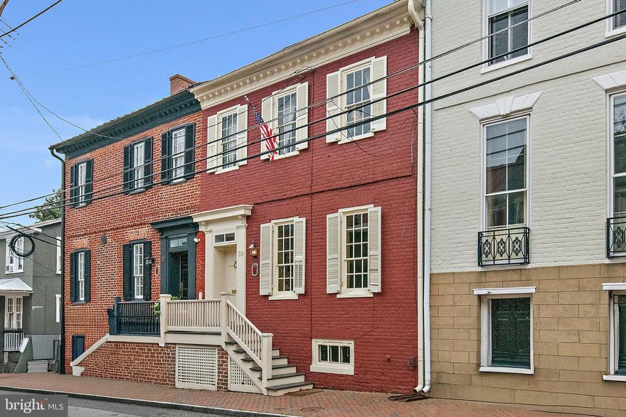 This historic and inviting Colonial home, built in 1786, is uniquely charming with large, elegant living spaces. Full of sophistication, it is also exceptionally comfortable and livable. Built as a tavern that Thomas Jefferson famously visited, 39 Cornhill is considered one of the best surviving homes of its kind in America with a remarkable amount of original material.  This meticulously maintained residence invites you to experience the best of life in Annapolis as it has been enjoyed for centuries. 

Unwind in the sunny living room with original wide-plank pine floors and custom cabinets.  Enjoy an intimate dinner or host large parties in the pleasant dining room space. Gaze out the bright and airy kitchen’s large windows at the private courtyard outside. Oversized custom cabinets, generous storage, plenty of counter space and room for dining are all part of this exceptional kitchen. The laundry room and a powder room are conveniently located off the kitchen. Another kitchen door leads directly to the pleasant outdoor courtyard, perfect for relaxing or entertaining. 

The home’s elegant front door opens to a wide entrance hall, the elegant living and dining rooms and the original staircase with impressive architectural detail. A large coat closet provides plenty of storage. On the second level, the serene primary bedroom includes exceptionally roomy closets. Three additional bedrooms are comfortable spaces for guests and/or home offices, ensuring flexibility to suit your lifestyle. The attic features a huge storage area and the basement is newly improved. 

In this historic home, the charm of downtown Annapolis surrounds you and calls you to be part of its rich history and vibrant lifestyle.  BONUS-Rented parking and garage just outside the back gate through the deeded access to the alley.