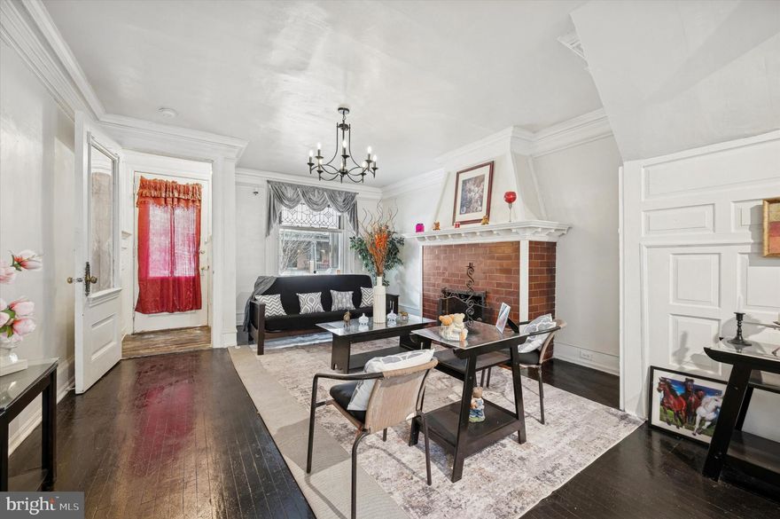 Welcome home to your sunlight filled multi level townhome that blends early twentieth century character with thoughtful updates. The main level welcomes you with  a vestibule entrance that leads to a cozy living room complete with fireplace, old world moldings and trim and an oversized window.  The dining area leads you to an efficient and modernized kitchen,  perfect for everyday cooking and complete with a gas range, microwave, granite countertops and refrigerator.  From here, there is an exit door to your fully fenced in backyard. Upstairs the second level hosts a full bathroom with a shower stall plus the primary bedroom and two additional bedrooms ideal for family or flexible use. The primary bedroom boasts your second fireplace.  The third level offers a second full bathroom with a shower stall and three more bedrooms that can accommodate guests, an office, or creative space. An unfinished attic provides storage or future expansion potential. The finished basement adds significant usable living space with a full bathroom with tub, generous storage, and a bonus room that works well as a rec room, home gym, or media room. This home sits in a vibrant neighborhood known for its abundance of classic row homes and a strong sense of community. The area offers convenient access to local shops, dining options, parks, and public transit making it easy to enjoy city living while still finding quiet residential pockets. Built with period details common to early twentieth century construction, this property presents a rare opportunity for buyers and investors seeking a spacious layout across multiple floors plus the flexibility of a finished basement. Public records and recent market listings indicate similar homes in the block have been updated and offered strong interest from buyers looking for space and value in the neighborhood. Both fireplaces are assumed to be working, however the seller has never used them.  Schedule your showing today!