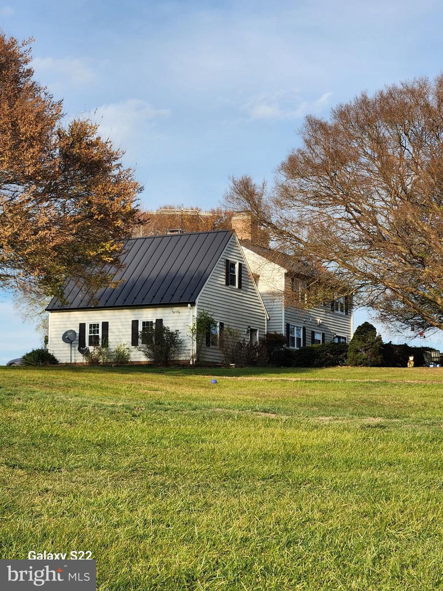 Nestled on a sprawling 19.39-acre lot, this exquisite Colonial-style residence offers a harmonious blend of luxury and comfort, perfect for those seeking a country lifestyle. The property, thoughtfully renovated in 2020, showcases a timeless design with modern amenities, ensuring a warm and inviting atmosphere throughout. Step inside to discover a spacious interior adorned with rich hardwood flooring and  crown moldings. The traditional floor plan features a formal dining room, ideal for hosting gatherings, and a cozy family room that seamlessly connects to the eat-in kitchen. The kitchen has hardwood floors, a double oven, electric range, and a stylish cooktop, all complemented by an efficient exhaust fan and a convenient dishwasher. Enjoy your morning coffee in the charming breakfast area, bathed in natural light from energy-efficient windows. With four  generously sized bedrooms and two and a half bathrooms, this home provides ample space for relaxation and privacy. The inviting family room, complete with a gas/propane fireplace, serves as the heart of the home, while an additional fireplace in the living area adds a touch of warmth and elegance. The partially finished basement offers versatile space for a home gym, workshop, or additional storage. The exterior of the property is equally impressive, featuring extensive hardscaping that enhances the outdoor living experience. A spacious patio invites you to unwind while taking in the serene views of the surrounding pastures. For equestrian enthusiasts, the property is a true paradise, boasting a range of horse amenities including a riding ring, stable, paddock, and an arena, all designed to cater to your equestrian needs. Additional features include an oversized attached garage with space for two vehicles, a stone driveway for added charm, and multiple outbuildings for storage or hobby use. The property is securely gated, providing peace of mind while you enjoy the tranquility of rural living. This exceptional residence not only offers a desired lifestyle but also a unique opportunity to embrace the joys of country living, all while being just a short drive from urban conveniences. Experience the perfect blend of  comfort, and equestrian amenities in this stunning home. Zoned AR1 endless possibilities, bring your pets, grow your vineyard, grow your own garden and ride in the beautiful field surrounding your home. Seller not responsible for roll back taxes, Non HOA.
