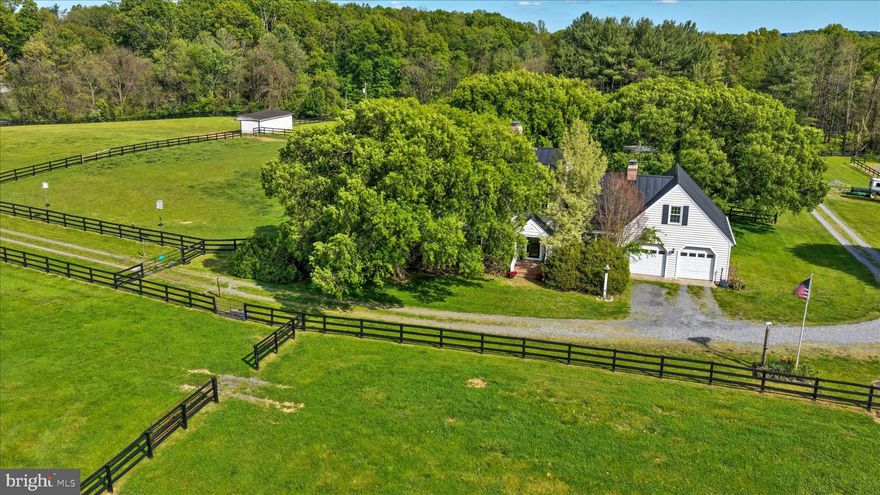 Nestled on a sprawling 19.39-acre lot, this exquisite country home  and Colonial style residence offers a harmonious blend of country living  and comfort, perfect for those seeking a quiet country lifestyle yet minutes away from town. Here you can enjoy your  horses, chickens, and farm animals.  Imagine, growing your own garden, flowers, vegetables, and being with nature. There is plenty of acreage here to live the dream away from city, but close to town of Purcellville and Middleburg. The property is recently updated  with a new roof, (2020) , new windows (2025), new drain field (2021), new  well pumps (2 wells).  This lovely home has two fireplaces, (one gas, one wood) and showcases a timeless design with modern amenities. Ensuring a warm and inviting atmosphere throughout. Step inside to discover a spacious interior adorned with rich hardwood flooring and  crown moldings. The traditional floor plan features a formal dining room, ideal for hosting gatherings, and a cozy family room that seamlessly connects to the eat-in kitchen. The kitchen is ideal for entertaining, a double oven, electric range, and a stylish cooktop, all complemented by an efficient exhaust fan and a convenient dishwasher. Walk out to your patio and enjoy your morning coffee. The home is  bathed in natural light from energy-efficient windows  and views from every room.  
With four  generously sized bedrooms and two and a half bathrooms, this home provides ample space for relaxation and privacy. The inviting family room, complete with a gas/propane fireplace, serves as the heart of the home, while an additional fireplace in the living area adds a touch of warmth and elegance. The partially finished basement offers versatile space for a home gym, workshop, or additional storage. The exterior of the property is equally impressive, featuring extensive hardscaping that enhances the outdoor living experience. A spacious patio invites you to unwind while taking in the serene views of the surrounding pastures. 
For equestrian enthusiasts, the property is a true paradise, boasting a range of horse amenities including a lighted riding ring, stable, (8 stall center isle barn)  including tack room, feed room, wash rack, paddock, an arena, all designed to cater to your equestrian needs. Additional features include an oversized attached garage with space for two vehicles, a stone driveway that can accommodate 10 cars. There are multiple outbuildings including an additional 4 stall  shed, run in sheds , chicken house and  for storage or hobby use. The property is securely gated, there are two entrances providing peace of mind while you enjoy the tranquility of rural living. This exceptional residence not only offers a desired lifestyle but also a unique opportunity to embrace the joys of country living, all while being just a short drive from urban conveniences. Experience the perfect blend of  comfort, and equestrian amenities in this stunning home. Zoned AR1 endless possibilities, bring your pets, grow your vineyard, grow your own garden and ride in the beautiful field surrounding your home. 
You can build another home for a family compound, with over 19 acres there is plenty of room!
Seller not responsible for roll back taxes, Non HOA.