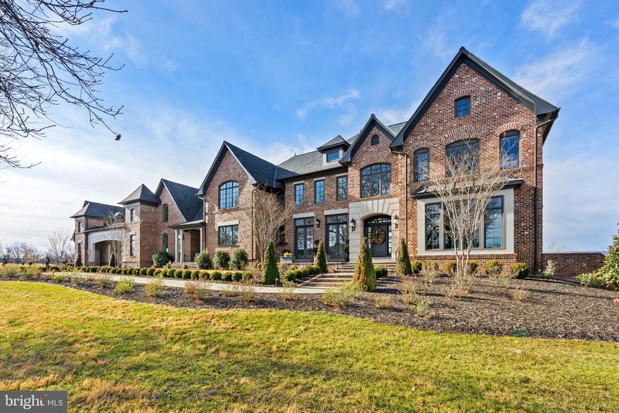 Welcome to Belvedere — A Legendary Middleburg Estate of Distinction and Unmatched Privacy
Perched majestically in the countryside with sweeping panoramic views of the Blue Ridge Mountains, this extraordinary gated estate offers an unparalleled country lifestyle just minutes from historic downtown Middleburg. Spanning approximately 27.53 serene acres, 21051 St Louis Rd embodies timeless elegance, exquisite craftsmanship, and modern luxury — a truly singular property for the most discerning buyer.
As you approach through commanding stone pillars, a sweeping paved driveway, and classic four-board black fencing, you are greeted by an atmosphere of refined grandeur. The landscaped grounds feature lush pastures, mature ornamental plantings, newly added perimeter and cross fencing, and multiple outdoor living areas including a charming pergola and expansive terraces that frame unforgettable views.
This exceptional residence — designed by respected architect James MacDonald of the Lessard Group and built by University Homes — is acclaimed for its architectural integrity and superior construction quality. Every detail has been thoughtfully designed and executed, including interior accents, Brazilian cherry hardwood floors on the main level, updated lighting, and more.
Boasting over 8,400 square feet of meticulously finished living space with a thoughtful, light-filled plan, the estate includes formal and informal entertaining rooms ideal for both grand affairs and intimate gatherings. High ceilings, elegant crown moldings, dual staircases, and expansive windows create an atmosphere of effortless sophistication.
The gourmet chef’s kitchen is a showpiece of culinary design — anchored by Cambria quartz countertops, a striking tile backsplash, top-tier Wolf appliances including commercial-grade range and double ovens, an oversized island, custom cabinetry, and adjoining butler’s pantry — delivering both style and functionality for entertaining at any scale.
Flowing gracefully from the kitchen, the great room and formal dining spaces provide picturesque views of the estate’s sprawling lawn, ideal for indoor-outdoor living and hosting seasonal events. A vaulted, screened porch offers a peaceful retreat to savor morning coffee or evening sunsets against a backdrop of rolling countryside.
The luxurious Owner’s Suite is a private haven, fully remodeled with spa-inspired bath finishes, bespoke lighting, refined plumbing fixtures, premium tile work, and serene natural light. Additional bedrooms offer generous proportions, abundant closet space, and thoughtfully designed baths.
A remarkable feature of this estate is the attached carriage house, connected by a covered breezeway and providing complete privacy for guests or extended family. This well-appointed space includes a full kitchen, living and dining area, a bedroom suite with walk-in closet, and a one-car garage, making it ideal for visitors or as a separate income-producing quarters.
Beyond its beautiful interiors, this estate delivers functionality and comfort with a four-car attached garage, full basement with walkout access, central vacuum, security system, extensive hardscape patios, and underground utilities. The land, zoned AR2, is fully fenced and can easily accommodate horses, livestock, gardens, or other country pursuits.
Belvedere’s location strikes an exceptional balance — offering complete privacy and tranquility while remaining moments from the cultural richness of downtown Middleburg’s fine dining, specialty shops, art galleries, equestrian facilities, and community events. This is a rare opportunity to own a signature estate that embodies the very essence of Virginia countryside living at its highest level.

Experience luxury, privacy, and panoramic beauty!

No Drive By's.
