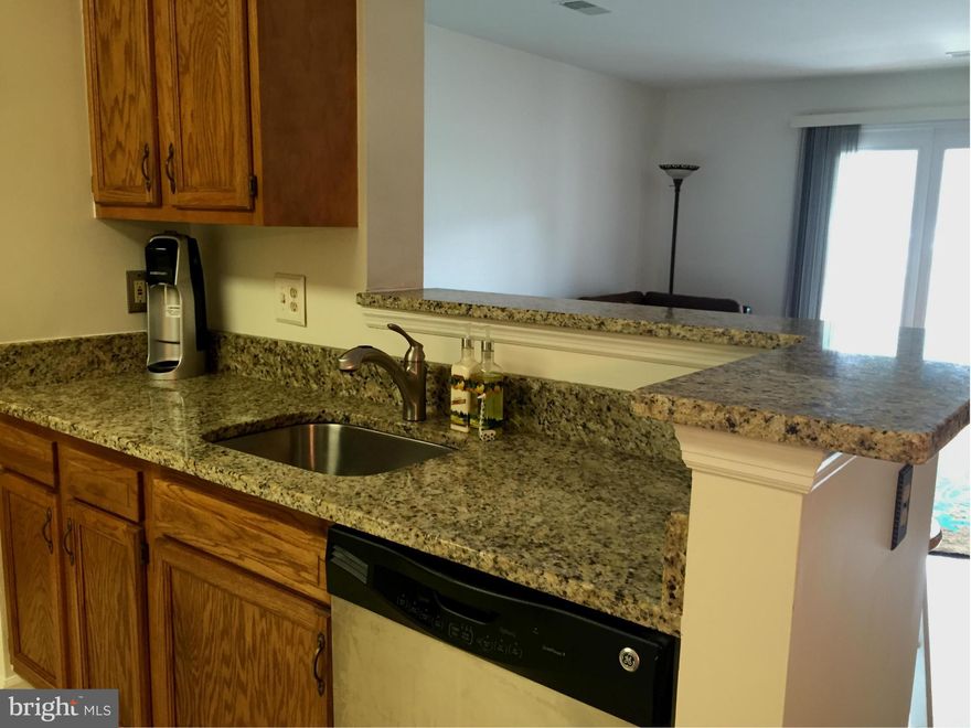 Updated kitchen w/ granite, SS appliances, ceramic tile, space for eat-in & bar stool area; LR w/ hardwds & fireplace, Separate Dining Room w/ hardwds; Large BRs, lots of closet space, walk-in, MBth w/ dual sinks, soaking tub & separate shower; In-unit full size washer/dryer; Just painted throughout; Storage room off private balcony; Convenient to Kingstowne amenities, near metro & Fort Belvoir.