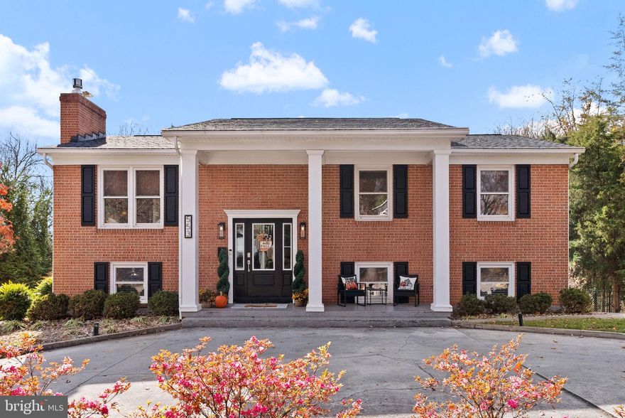 Perfectly poised on a quiet lot embraced by mature, stately trees, this 5-bedroom, 2.5-bathroom home offers both seclusion and incredible proximity to Winchester's finest amenities, schools, shopping, and major commuter routes. This residence has been completely reimagined, blending the enduring strength of all-brick construction with bespoke, high-end modern finishes. The moment you enter, you are greeted by the seamless flow of newer, wide-plank LVP flooring that extends throughout, complemented by designer-selected, upgraded light fixtures that cast a warm, ambient glow. The heart of the home is the gourmet chef's kitchen, a true culinary sanctuary. It features sleek, upgraded counters, stunning subway tile walls, open floating shelves for display, and a massive center island that serves as the perfect gathering spot. Outfitted with a suite of newer, top-tier appliances, this space is designed for both grand entertaining and intimate dining. The adjacent main level living area provides warmth and ambiance with a wood-burning fireplace, an ideal setting for cozy evenings. The main level also encompasses three spacious bedrooms and a convenient 1.5 bath setup. The spa-like ensuite primary bath is appointed with sinks for two, exquisite custom tile work and is anchored by an impressive glass-enclosed shower. You can enjoy peace of mind knowing that every bath in the home has been newly renovated and finished to the same superior standard of modern luxury. A truly exceptional feature is the fully-finished, walkout lower level, offering an incredible extension of living space. This level includes two additional bedrooms, a pristine full bathroom, and a highly functional laundry command center featuring extensive counter space, custom cabinetry, and a utility sink—elevating laundry from a chore to a convenience. The exterior of the property seamlessly transforms into your exclusive private retreat. The presence is enhanced by the circular driveway, ensuring generous off-street parking for residents and guests. The outdoor space offers a large screened-in porch ideal for bug-free relaxation, and a versatile lower paved patio for gatherings. For elevated functionality and architectural interest, a spiral staircase descends gracefully from the upper deck to the lower level. Completing the luxury amenities, a relaxing hot tub awaits, offering the ultimate sanctuary for year-round indulgence. An added shed provides discreet storage for tools and equipment. Offering perfection around every corner, this is a turn-key residence where the finest materials and thoughtful design converge. Your elevated Winchester lifestyle begins here.