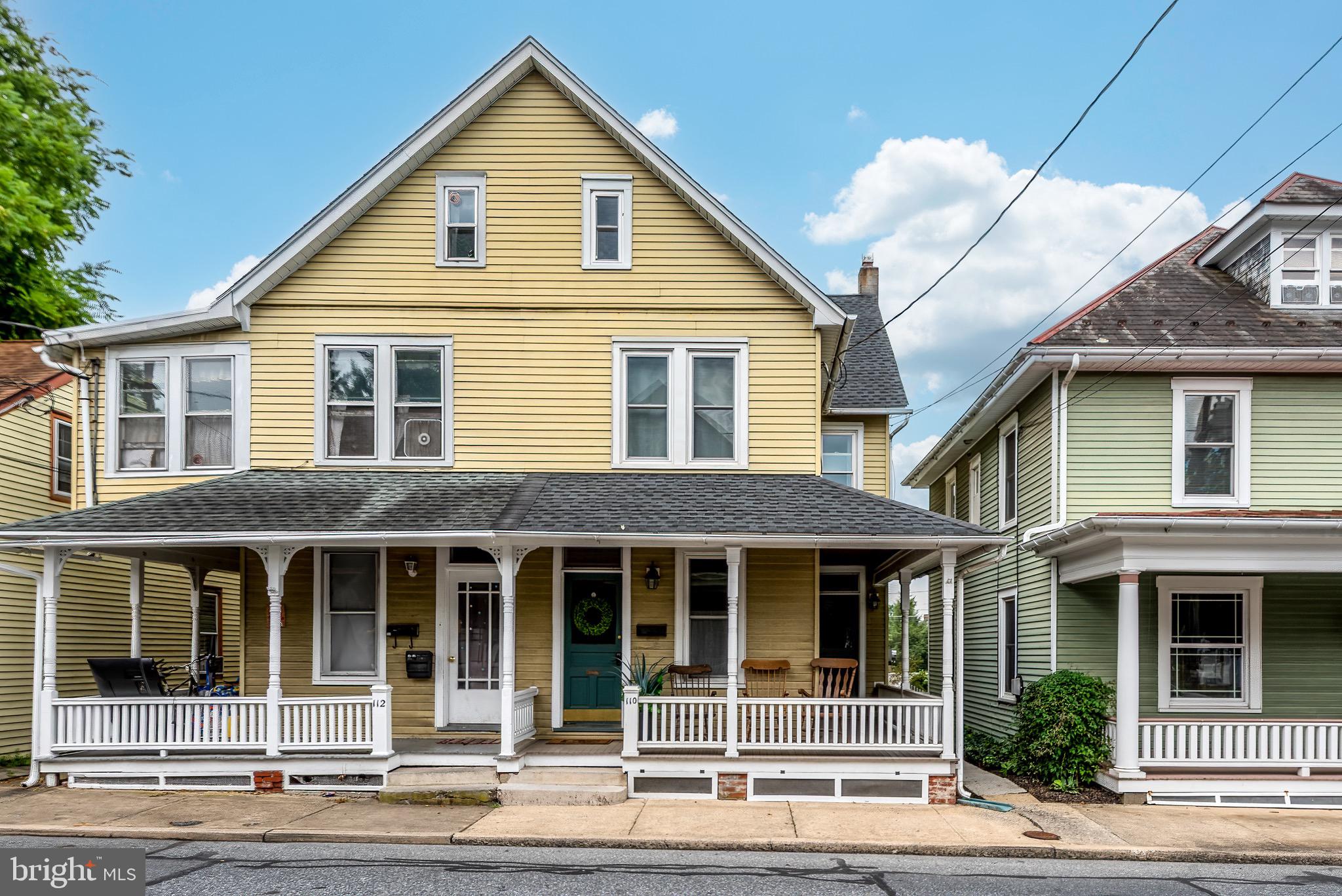 Welcome to 110 E. Lincoln Ave – where timeless charm meets everyday comfort in the heart of Lititz. Built in 1930, this beautifully maintained semi-detached home invites you in with a broad front porch—perfect for rocking chairs and sipping lemonade on warm summer afternoons. Step inside to a welcoming living room, where plush carpet, tall windows, and stunning original woodwork create a space that’s both cozy and elegant. A graceful pillared archway leads into the formal dining room, where gleaming luxury vinyl plank floors and elegant lighting make it ideal for gathering with loved ones around a grand holiday meal or a quiet candlelit dinner.
The kitchen is a true delight—spacious and flooded with natural light. Shaker-style cabinetry, luxury vinyl floors, expansive countertops, and calming color palette make this the heart of the home. There’s even room to add an island or breakfast nook for feasting on Saturday morning pancakes or sipping your morning coffee. Just off the kitchen, a practical mudroom leads to a dedicated laundry area and a convenient powder room, offering thoughtful functionality for daily living.
Upstairs, you’ll find three warm and inviting bedrooms. The primary bedroom offers generous space, large windows, and plush carpeting—perfect for stretching out and unwinding with your favorite Netflix series. Two additional bedrooms provide peaceful retreats with plenty of privacy and comfort. The full bathroom features stylish new tiling for a spa-like feel.
Need more space? A huge unfinished attic offers endless potential—whether you’re dreaming of a fourth bedroom, home office, art studio, or playroom. The full unfinished basement adds even more storage and versatility. Outdoors, enjoy a low-maintenance trex composite deck, a fenced-in backyard, a workshop space with additional space upstairs for hobbies or projects, and even an off-street parking spot—an added convenience in this amazing location. Nestled just blocks from downtown Lititz, this is a home you will not want to miss.