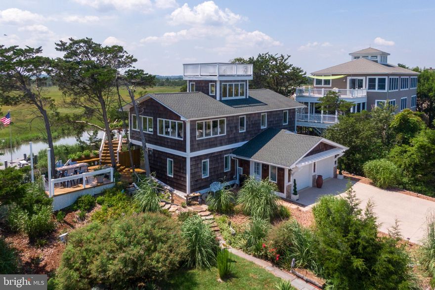 Nestled in the serene enclave of Broadkill Beach, this exquisite coastal bungalow offers a harmonious blend of luxury and comfort, perfect for those seeking an exclusive lifestyle by the water. With 1,176 square feet of thoughtfully designed living space, this home invites you to experience the ultimate in relaxation and leisure. Step inside to discover an open floor plan that seamlessly connects the living, dining, and kitchen areas, creating an inviting atmosphere for gatherings and cherished moments. The family room, conveniently located off the kitchen, is adorned with ceiling fans and large casement windows that flood the space with natural light, enhancing the warm ambiance. The kitchen is a culinary enthusiast's dream, featuring stainless steel appliances, including a dishwasher and an electric oven/range, complemented by an extra refrigerator/freezer for added convenience. The interior is elegantly furnished, ensuring a cozy yet sophisticated feel throughout. The ceramic tile and plush carpet flooring provide both style and comfort, making every step a pleasure. Venture outside to discover the extensive hardscape that surrounds the property, designed for both beauty and functionality. Enjoy evenings under the stars with exterior lighting that sets the perfect mood. An outside shower adds a touch of convenience after a day spent at the nearby private beach, where you can indulge in swimming, fishing, or simply soaking up the sun. For those who appreciate the finer things in life, the roof deck offers breathtaking views of the Delaware Bay and Deep Home Creek, creating an idyllic setting for morning coffee or sunset cocktails. The property also boasts a concrete driveway leading to an attached garage, providing ample storage and easy access. Water enthusiasts will revel in the private access to the creek, perfect for boating, kayaking, and waterskiing. This home is not just a residence; it's a gateway to a lifestyle filled with adventure and tranquility. With its prime location, luxurious features, and a welcoming atmosphere, this Broadkill Beach bungalow is more than just a home; it's a sanctuary where cherished memories are made. Embrace the coastal lifestyle and make this exquisite property your own.