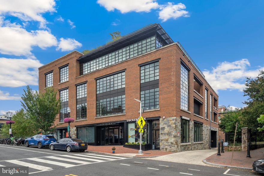 Experience riverfront living at its finest in this remarkable Georgetown penthouse, where walls of glass frame sweeping Potomac views and an open layout flows seamlessly to a private terrace. The gourmet kitchen centers around a striking stone island, complemented by a custom wood-paneled office, four private bedroom suites, and three separate entrances for ultimate convenience and privacy. This exclusive seven-residence building offers amenities designed for both luxury and wellness, including a rooftop pool with grilling area, a fully equipped fitness center, concierge service, a state-of-the-art fresh air filtration system, extra storage, and secure garage parking for four vehicles.