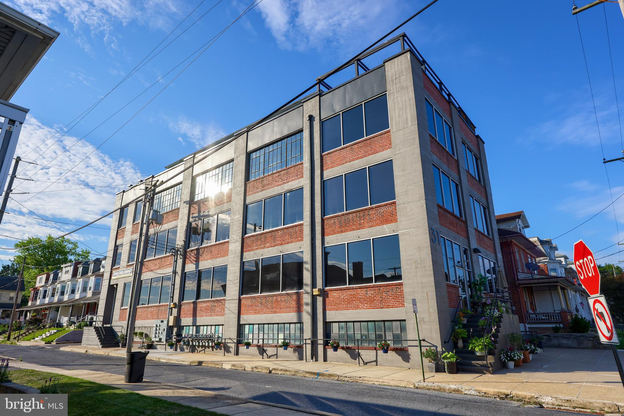 Loft Condos at Sterley
This completely renovated luxury condo building gives residents the opportunity to feel like a true city slicker - without paying like one! Located in Shillington, close to a variety of restaurants and amenities, as well as Governor Mifflin high school. Through the main entrance is a welcoming common area, enhanced by high ceilings and large windows with an awesome old school service elevator with sliding garage door entry. The unit's open concept draws you from the main living space, featuring tile and vinyl flooring, high ceilings, and exposed brick. The kitchen and dining area is an entertainer's dream, featuring KraftMaid cabinetry with granite countertops and tile backsplash, stainless steel appliances, double sink, and floating breakfast bar that overlooks the open dining space. Each bedroom is enhanced by newer vinyl flooring and large windows, while the shared bathroom has a tile shower/tub. Complete with its own laundry, extra home office space and a private garage available for added storage and convenience. This 1427 SF unit is connected to a separate, 1773 SF commercial unit with modern feel, industrial touches, boasting large open spaces, a kitchenette, power room, and storage! Completely versatile for any home office needs.