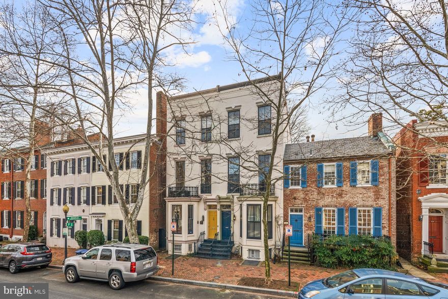 NEW PRICE! Featured as House of the Week in the Washington Post! Nestled along a charming tree-lined street in Georgetown’s beloved East Village, 3040 P Street, NW presents an elegantly reimagined 1876 semi-detached Victorian townhome of gracious scale and refined design. Having undergone a renovation by renowned architect Christian Zapatka, the residence boasts luxurious fixtures, high-quality finishes and modern upgrades while seamlessly preserving the timeless design notes, magnificent millwork, soaring ceilings, and historic charm of the original architecture’s integrity. Zapatka’s masterful work includes a complete reconfiguration of the Main Level’s floor plan, moving the home’s Gourmet Kitchen to the rear of the residence to allow for spacious entertaining salons, enchanting views from a newly installed wall of windows, and effortless access to the serenely private Southern Garden. The 4-level home features 3 Bedrooms, 2 Full Bathrooms, and one half Bathroom across a sprawling 2,850 total square feet on all levels. Offering breathtaking Washington Monument views from the Third Level, an idyllic walkout rear Garden, and unbeatable proximity to the design, dining, and entertainment destinations of Georgetown’s revered M Street; this extraordinary Victorian is a true gem sited in a priceless locale.
