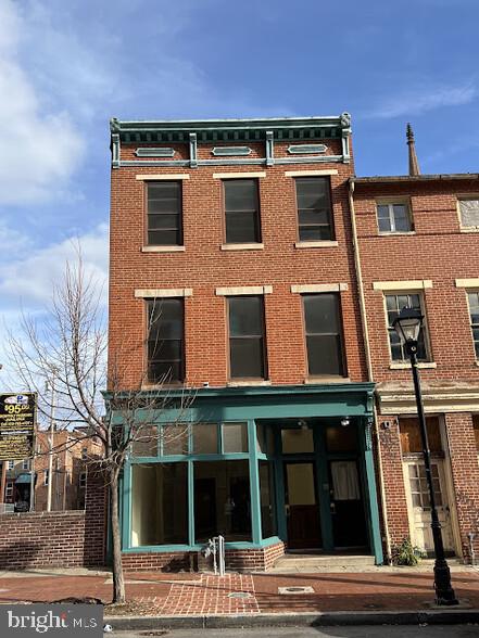 Unique investment opportunity: mixed use rowhouse on Baltimore's historic "Antique Row" with six parking spaces. Across Howard Street from the University of Maryland Medical Center's Midtown Campus, home to 1,400 employees and 500 physicians. Move-in ready. New HVAC systems, washer/dryer, refreshed parking lot. New paint inside and out, new light fixtures, new water heater, new water pipes. Caution: seeing this property may inspire urge to own it! (1) The ground floor is high-visibility space ideal for restaurant or retail use. Previously lessees include a bookstore, art gallery and tattoo parlor. Separately metered gas and electric. (2) The upstairs 3-bedroom apartment is gorgeous with sun-drenched rooms, spectacular fireplaces, fully equipped kitchen plus washer/dryer, and huge basement for storage. Separately metered gas and electric.