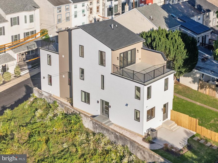 Conshohocken Luxury Awaits!  This new construction home features 4 bedrooms, 4 bathrooms, fantastic location with expansive views, and all of the high-end features you could dream of!  This home has been thoughtfully designed and meticulously crafted for the most discerning buyer.  The main level features 9' ceilings, tons of light and an open floor plan that's perfect for modern convenient living.  A sparkling kitchen is the heart of the home;  chef or not, you will fall in love with the layout and luxurious features.  Barley and Pearly White  Shaker cabinetry in contrasting  colors, beautiful quartz countertops, stainless steel appliances including an executive SS 6-burner gas range with a SS and white hood. Additionally there is a GE Profile electric wall oven / microwave above, refrigerator with a unique interior water pitcher plus beverage drawer, pot filler and Thor wine / beverage refrigerator.  The large center island (seating for 5-6) creates a space to gather for a peaceful Sunday breakfast or lively holiday entertaining.  No design detail was overlooked - from the gorgeous kitchen hardware, impressive full wall fishtail backsplash, soft close drawers, there is even gold floor stoppers at the entry doors!  The dining and living area are elevated with a flu-less gas fireplace , custom Italian tile surround, a large wood mantle and a Gold wall Nest.  A convenient full bathroom, laundry and a bedroom / office  are also located on this floor.  On the second level, you will find 3 bedrooms and 2 full bathrooms. The spacious Owner's Suite has beautiful windows for plenty of natural light and lead to lovely views + 2 closets (one a large  walk-in).  A spacious en-suite bathroom is the perfect place to melt away the stress of the day -  featuring spa blue custom cabinetry / crown molding,  2 sinks with quartz tops, 2 Smart mirrors that include a de-fogging feature, an oversized shower w/ frameless glass and pebble stone flooring,  boasting one sheet large shower surround tiles and a Bluetooth speaker!  Two more bedrooms and a full hall bathroom that includes a soaking tub and Sage Green tile  surround complete this floor.  The third level is flexible space that could be used as a second Owner's Suite (or a 5th bedroom), an entertaining space, office, a place for your hobbies, the  kids or a knock out in-law suite!  This large open space has a custom wet bar,  a full bath with gorgeous large Navy Blue and Gold shower tiles, frameless glass and a Bluetooth speaker. If this was not enough, it has 2 decks on both the front and back with black 42" welded steel railings, electric outlets and hose bibs for easy cleaning!  The views are endless - imagine being able to watch both the sunrise with your morning coffee, and the sunset with a happy hour cocktail.  This third level has something for everyone.   Additionally, there is a rear patio off the kitchen that would be the perfect place for a fire pit in the upcoming Autumn months.  Some luxury extras include: Exterior lighting, wood interior doors, and custom designed bathrooms with LED mirrors!  All of this, plus 2-3 dedicated parking spaces,  a partially finished lower level with a Huge storage area and additional  closets. Access to the home is a breeze from both the front and the rear.  Front stairs lead to a custom shelled walkway and entrance to the main level.  There is also a lower-level entrance in the front, leading to the partially finished lower level with stairs up to the main level (this could make for a convenient mudroom or drop-zone for bags, bringing in your bikes  & equipment).  In the rear, two private side-by-side parking spaces lead directly to the kitchen entrance.  Centrally located in Downtown Conshohocken, within walking distance to all of the fantastic restaurants & shops, SEPTA train, and fun events all throughout the year!  Showings to begin 10/2... You simply must see this luxury home in person to appreciate the meticulous detail and craftsmanship.