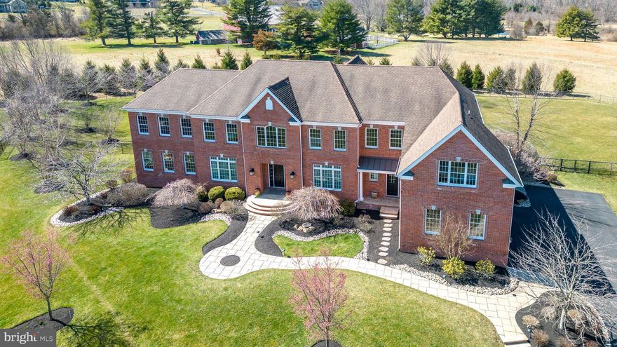 Exquisite executive estate beautifully appointed Penn Wynne model offering over 7600 sq ft of custom features indoor on the main and upper levels, with additional outdoor custom features awaits you. The main floor offers a center hall formal foyer with coffered ceiling and hallway leading to French door access to the outdoor area. An expansive formal dining room with coffered ceiling, formal living room with coffered ceiling offering access to a solarium featuring travertine tile floor, and surrounded with windows are featured on the main level. The custom expansive gourmet kitchen features double door Subzero refrigerator, Professional Wolf range and hood, walk-in pantry, dry bar with wine refrigerator and expansive kitchen island with sous chef sink. An expanded breakfast room with vaulted ceiling and skylight opens to the family room and provides French door access to outdoor area. A coat room and laundry room area feature front entry and garage entry from the 3 car garage which offers a Tesla charging station. The grand 2 story family room is located off the breakfast room and features custom imported marble mantel from Turkey surrounding gas fireplace, with custom design tile work above mantel, custom floor to ceiling windows, and French doors leading back to formal dining room. 

The upper level of this home offers an elegant and spacious main bedroom featuring tray ceiling, walk-in closet with custom built-ins and dresser storage, dressing room with vanity, sitting room, exercise room, and a master bath with heated floor, custom stone walk-in shower, 2 full vanity sinks with an abundance of cabinet storage, and over-sized spa tub.  An additional custom designed bedroom suite with full bath, and walk-in closet featuring custom built-ins is also on this level. Two additional bedroom suites and a spacious loft area for lounging complete the upper level. The outdoor offers a custom designed outdoor kitchen featuring Wolf grill. A custom stone fireplace, patio pavilion, custom designed in-ground pool make this a true outdoor private oasis offering panoramic views of the historic Bucks County mountain side areas. Other fine features include hand scraped Brazilian cherry hardwood floors throughout, whole house generator, central vacuum system, water purifying system, Tesla charging station, custom stone walkways and patios, cast aluminum fencing, full bath in basement, and outdoor sprinkler system.