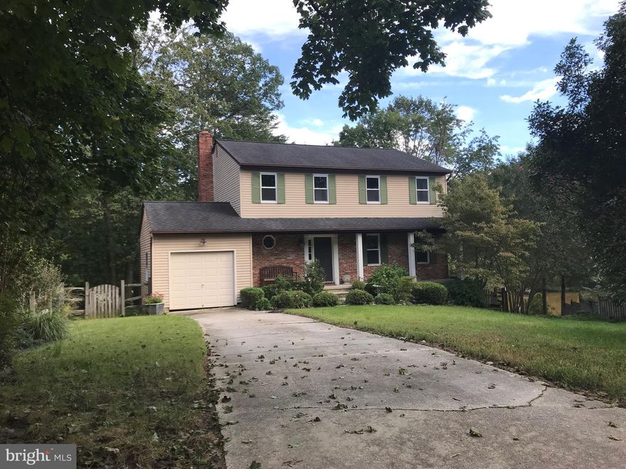 ATTAINABLE WATERFRONT!  If you love open concept you'll love this floor plan and the statement feature of the  stunning stacked stone travertine fireplace!  Hardwood flooring through out.  Gourmet kitchen w/ SS appl: gas cooktop, trash compactor, wine fridge. Plenty of Cherry cabinets! Awake to water views & travertine stone master bath with separate shower and soaking tub, double sink vanity. Master bedroom french doors step out to private full length deck overlooking creek.  Tons of closet space! Bedrooms 2 and 3 are roomy and feature double closets.  Updated tile shower with bench and vanity.  Two zone heating and a/c for main and upper level. Plan your dream finished basement w/walkout to backyard.  Large arched  windows  to view the expansive & private view of Mill Creek!  Steps to pier with boat lift. Quiet court in Divinity Cove. This community has its own community pier and picnic area and walking distance to the school and park.