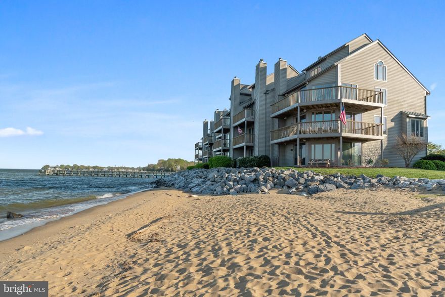 Stunning sunrises from this beautiful corner end -unit townhome right on the Chesapeake Bay. Enjoy the cool bay breezes.  Talk about picture perfect! Glass walls in the living room that affords expansive spectacular views of the Chesapeake Bay and sandy beach below.  Awake with the sound of beach waves. Bright modern kitchen features state of art appliances with open water views.  Time-saving breakfast bar for busy mornings.  Over-sized granite island with an abundance of cabinet storage. Cozy bay window Breakfast area.  Rich hardwoods.  Elegant comfortable living room with cozy wood-burning fireplace with panoramic views.  Private elevator access to all floors.   Luxurious Master bedroom with large closet + 2nd closet. You’ll love your sun deck off the Master suite.   Each of the four bedrooms includes en suite bath + an abundance of ample closet space.   Extra-sided windows make bedrooms light and cheery. Lower level guest suite walk right out to the beach. Garage with 2 additional storage areas/workshop & sink. The Gated community features Bayside pools, Marina, tennis courts, and  Sam’s waterfront restaurant. Don’t miss out on the opportunity to live the wonderful waterfront lifestyle in Chesapeake Harbour.