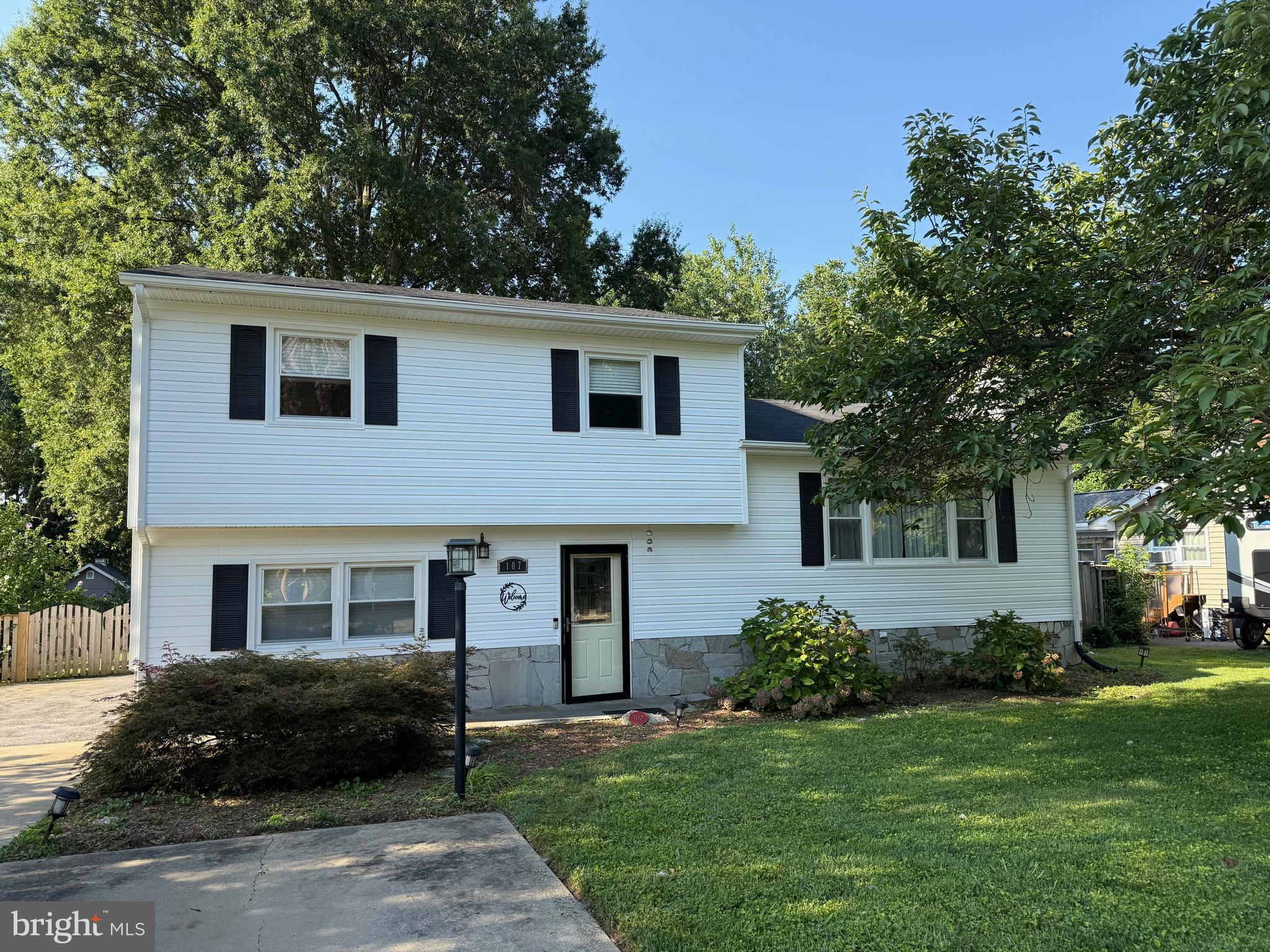 This Hillsmere Shores residence is conveniently located within walking distance of South River and Key School. The property features a flexible interior layout, including a main-level suite with a full bathroom and sitting area, currently utilized as a family room with a home office. A rear staircase offers secondary access to the updated kitchen, which showcases stainless steel appliances and granite countertops. Hardwood floors extend throughout the living and dining areas, as well as three bedrooms. The living room includes a fireplace, "as is" with an electric insert, while the dining area, with cabinetry—opens to a climate-controlled four-season room Bedroom level has 3 bedrooms one bedroom has "ensuite" access to the hallway full bathroom. The fenced rear yard features a firepit area, patio, expansive green space, established gardens, and a potting shed. Ample driveway and off-street parking. Hillsmere community offers the residents a
voluntary community association ; access to a beach, marina, boat ramp, as well as an optional community pool membership. The location is within walking distance to the library and Quiet Waters Park, and is convenient to shopping, restaurants, gas stations, Historic Annapolis, and the U.S. Naval Academy.