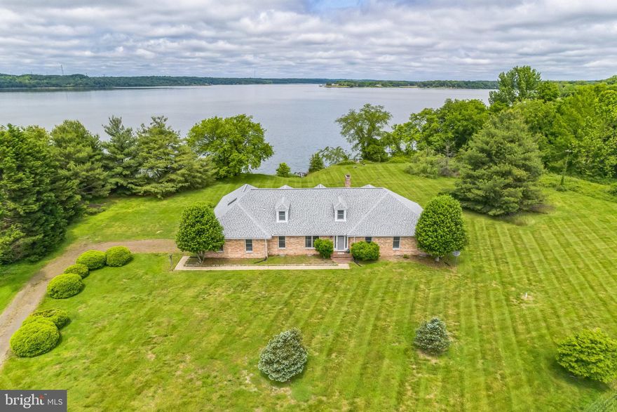 Welcome to your waterfront retreat on the Patuxent River! This remarkable property, nestled on a generous 7.69-acre lot offers a unique opportunity to embrace a serene and idyllic lifestyle. A perfect combination of timeless charm, and beautiful views surrounded by rural farmland awaits your arrival for a preview. Backup offers will be presented
     As you approach the property, you are greeted by a natural landscape where the sounds of chirping Osprey nesting nearby and the soothing views of the waters calm the mind. The property boasts a blend of lush greenery, a stately brick home, and solitude. Stepping inside, you are immediately captivated by the panoramic views of the river that grace every corner of this residence. The interior features an open and inviting floor plan, designed to optimize natural light and breathtaking water vistas. With generous windows and glass doors throughout, this home ensures seamless integration between the indoors and the captivating scenery that lies beyond.
     The main living areas exude warmth and comfort with a cozy stone fireplace serving as the living room's centerpiece, perfect for gathering with loved ones on chilly evenings. The kitchen offers a delightful space for culinary creations, equipped with a built-in oven, microwave, Jennair cooktop, and ample cabinetry. 
 Whether hosting a  dinner party in the dining room or enjoying a casual meal on the enclosed porch, every meal will be accompanied by stunning views of the river.
     The primary suite on the main level provides a quiet haven to unwind and rejuvenate. Wake up to awe-inspiring sunlight over the water and sunsets to end your day. The en-suite bathroom is complete with a spa-like soaking tub, a separate shower, and dual vanities. Additional bedrooms offer comfort and privacy for family members or guests, and the bathrooms ensure everyone's needs are met with style and functionality. The separate utility room and attached 2 car garage are convenient as well.
     An upper level offers two separate bedrooms plus a sitting area -or perhaps you prefer an office area and workout room.  It's nice to have choices and ideas to satisfy your needs with plenty of living areas to do so.
     Located on the coveted Patuxent River, this home offers the best of both worlds — a secluded retreat away from the hustle and bustle of city life, yet within easy reach of modern conveniences and amenities. Whether you're seeking a peaceful escape or a place to create lasting memories, this waterfront property is an exceptional find that beckons you to embrace the beauty and tranquility of waterfront living. A small walkway with steps to the water and beach area. Perfect for launching kayaks and swimming.
     Don't miss this once-in-a-lifetime opportunity to own your slice of paradise.  Located only 50 miles from the DC, Alexandria VA, and the Annapolis area. A few updates and personal touches will make this home reflect your style.  Schedule a private showing today and let this waterfront home on the Patuxent River captivate your heart.