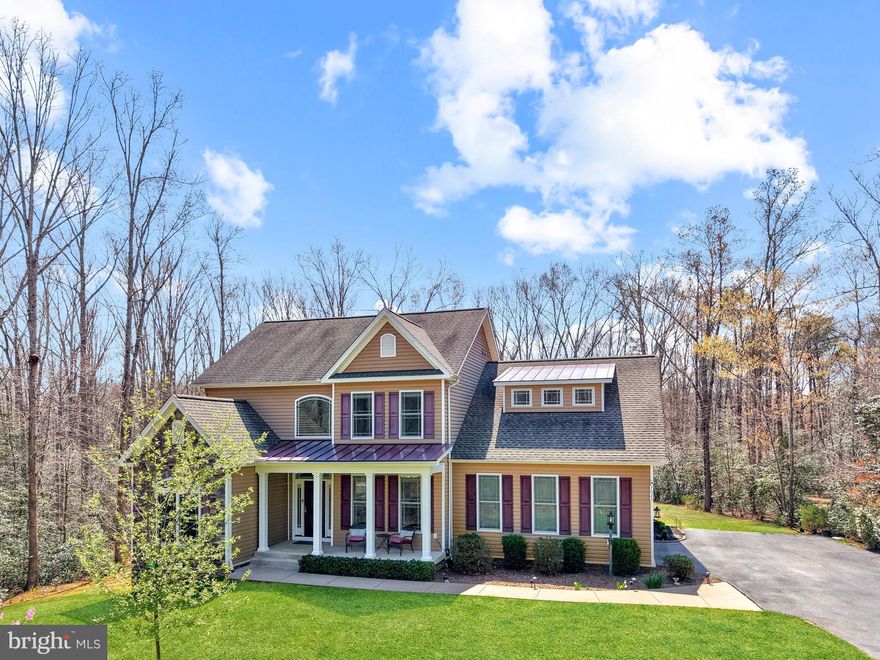 Welcome to this stunning custom-built home at 7022 Barclay Drive, the original model home in the coveted River Glen subdivision. This spacious residence offers nearly 5,000 square feet of finished living space on a beautiful and private 2-acre lot. Built in 2015, the home features thoughtful upgrades, abundant natural light, and versatile living areas across three finished levels—perfect for comfortable everyday living and entertaining.

Step through the impressive front door into a welcoming foyer with hardwood floors throughout the main level. To the left, you’ll find a dedicated office, a convenient powder room, and a coat closet. To the right, the elegant dining room showcases chair rail and crown molding.

The spacious family room is filled with natural light and features a gas fireplace and built-in shelving. The recently remodeled kitchen serves as the heart of the home, complete with a large peninsula, a separate island, brand-new quartz countertops and backsplash, wood cabinetry, a microwave and oven combo unit, and stainless steel appliances. An eat-in area provides direct access to the screened porch and opens to an expansive 12x25 composite deck with vinyl railing—maintenance-free and ideal for outdoor gatherings.

The first-floor primary suite offers hardwood flooring, dual closets, and a luxurious en-suite bath with a soaking tub, dual vanities, a walk-in shower, and a private water closet. A mini-split system adds energy-efficient climate control. The laundry room, with washer and dryer that convey, is conveniently located between the kitchen and the oversized garage and includes additional linen and storage space.

Upstairs, wide stairways with wood treads lead to hardwood flooring throughout. A loft area provides flexible space for a home office or sitting area. The second primary suite features a recently remodeled bathroom with updated countertops, tile flooring, a tub/shower combination, and a separate toilet area. Two additional generously sized bedrooms and another full bathroom complete this level.

From the main level, hardwood stairs lead to the fully finished lower level with tile flooring and recessed lighting throughout. This level includes a multifunction room, finished storage areas, and a large family room accented with shiplap. A kitchenette/bar area features granite countertops, stainless steel appliances, a double sink, and ample space for entertaining.

Enjoy movie nights in the dedicated theater room equipped with six powered recliner seats, a projector, screen, and built-in candy shelving. A spacious fifth bedroom with a full-size window overlooking the backyard adds flexibility, along with a beautifully finished full bathroom featuring a tiled walk-in shower with dual shower heads and a large vanity. A screened patio off the lower-level family room extends the living space outdoors.

Additional features include a utility room with storage, a new HVAC system installed in 2025, a 75-gallon water heater, and a whole-house humidifier. The home is equipped with an active radon mitigation system, a 500-gallon leased propane tank, and well and septic systems with excellent water quality. The oversized two-car garage includes heavy-duty shelving and cabinetry that convey, and a hidden shed is tucked away at the rear of the property. The inviting front porch, large driveway with additional parking, and front yard sprinkler system add to the home’s functionality and curb appeal. The roof is original to the home.

Blending modern updates such as quartz and granite surfaces with timeless hardwood and tile finishes, this home offers exceptional comfort and style. Ideally situated on a private lot in a desirable location, it provides a peaceful setting just minutes from Central Park, Spotsylvania Towne Centre, and I-95.

Whether you’re seeking main-level living, multiple flexible spaces, or a fully finished basement with premium amenities, this home delivers outstanding value and versatility.