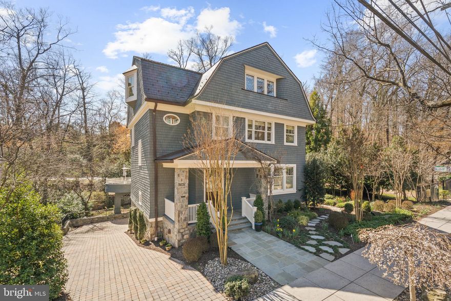 Designed by Ankie Barnes of Barnes Vanze Architects and built by Zuckerman Partners in 2012; 3038 Macomb St, NW’s 6100 square foot interior has been carefully maintained by its sole owner since delivery. Countless design notes and amenities are found throughout the residence from the soaring coffered, cathedral and 11’ vaulted ceilings;  elegant moldings; all-level, full-service elevator; gracious entertaining salons; decadent private suites; and gourmet kitchen. Showcasing 5 Bedrooms, 6 Full Bathrooms, and 2 Half Bathrooms across  4-levels, this Cleveland Park Colonial is a true showstopper. Backing to Tregaron Conservancy, the property’s parcel is brimming with mature professional landscaping and lush gardens. An attached sideloading Garage and paver driveway provide parking for 3-4 cars.
<br>
<br>
A flagstone walkway leads to the home’s unique cedar shake and copper façade with front porch, providing a charming welcome to the Colonial’s light-filled interiors. The Main Level’s floor plan debuts a seamless balance of perfectly appointed principal spaces, the Living and Dining Rooms; and more informal gathering spaces, the Family Room and Breakfast Area, providing optimal settings to host a crowd or lounge with family in ease. The Gourmet Kitchen is the true heart of this home. Boasting a center island with bar seating, abundant storage space and high-end appliances to include a 6-burner gas range. Open to both the formal Dining Room and spacious Family Room, entertaining and everyday living is a breeze. Adorned with beautiful, coffered ceilings and a wood-burning fireplace, the Family Room will make any guest feel right at home. An expansive Rear Deck is accessible by French doors and provides the perfect setting for alfresco dining overlooking the lush greenery of the lawn’s landscaping and Tregaron Conservancy. A Powder Room completes the Main Level’s offerings.
<br>
<br>
The primary suite is a well programmed space with southern views of the gardens below and Conservancy. The suite has an expansive Primary Bedroom, adjacent Sitting Room, dual outfitted dressing rooms, and two spa-like Bathrooms with a soaking tub and 2 walk-in showers. An additional ensuite Bedroom and conveniently appointed Laundry Closet complete the Second Level.
The colonial’s incredible scale extends to the Third Level of the residence with soaring 11’ vaulted ceilings adorning the level’s 2 ensuite Bedrooms and Loft space.
<br>
<br>
Multifunctional living is on display throughout the Lower Level’s flexible floor plan. Showcasing a spacious Recreation Room, 5th ensuite Bedroom, Laundry Room, Mudroom, Powder Room, Storage, and access to the attached sideloading Garage, the Lower Level offers abundant space and ample opportunities to fit the new owner’s needs.
<br>
<br>
Boasting exquisite design, incomparable craftsmanship, and incredible scale in prime Cleveland Park, this like-new Colonial home is a residential treasure sited in a priceless locale.