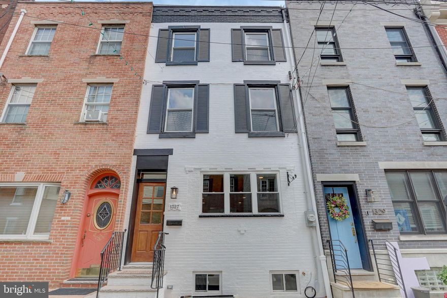 Nestled in the heart of Passyunk Square, this stunning fully renovated home stands as a testament to modern urban living. Boasting 3 bedrooms, 2.5 bathrooms, and a host of luxurious amenities, including a finished basement and a rooftop deck, this residence offers unparalleled comfort and style. Upon entry, you're greeted by a spacious living and dining area adorned with wide plank hardwood floors, complemented by a convenient powder room nearby. The expansive kitchen beckons with its 8' center island, custom hunter green cabinets, and Bespoke appliances. Step outside to a generous rear yard, perfect for hosting BBQs or cultivating your own urban oasis. Descend to the lower level, ideal for additional living space, complete with ample storage. Upstairs, discover two generously sized bedrooms and a beautifully appointed hallway bathroom, along with a convenient laundry room. The third floor unveils a private bedroom suite, featuring cathedral ceilings and exposed brick walls for a chic loft-style ambiance. Indulge in the lavish master bathroom with a deluxe 7' shower and Carrara marble countertops. The suite also includes a cozy sitting area with a dry bar and wine fridge, leading to a tranquil outdoor terrace, ideal for soaking in city sunsets. Enjoy the vibrant neighborhood amenities, from restaurants to cafés, all within walking distance, while being conveniently close to center city and public transportation. Complete with a washer/dryer and a one-year builder warranty, this home epitomizes contemporary city living at its finest. The only thing missing is you! Schedule your appointment today.