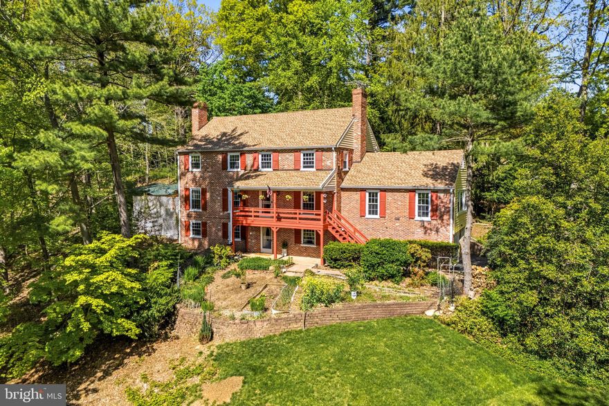 Welcome to 407 Margo Lane, ideally situated in Berwyn’s highly sought-after Woodlea neighborhood. This classic brick Colonial offers 5 bedrooms, 3.5 baths, and approx. 4000 sq ft of interior living space.  This thoughtfully designed layout  blends timeless character with everyday comfort and showcases sweeping sunset views from the inviting front porch.
A center hall foyer with staircase entry sets the tone, opening to spacious, light-filled living areas. The formal living room features a fireplace and flows seamlessly into the dining room, accented with chair rail detailing and perfectly positioned for gatherings. The expansive kitchen is the heart of the home, offering granite countertops, natural wood cabinetry, recessed lighting, and generous workspace for cooking and entertaining. Just beyond, a sun-drenched great room showcases built-in shelving, windows on all sides, and a brick fireplace with gas line hookup—creating a warm and welcoming space year-round.
The main level also offers exceptional versatility with a private office or study, a bright sunroom, a convenient laundry room with access to the rear patio, and a powder room. Indoor and outdoor spaces connect effortlessly, with access to a screened-in porch and side deck with over 600 Sq. Ft—ideal for relaxing or entertaining.
Upstairs, the primary suite provides a comfortable retreat with a walk-in closet featuring built-in organizers and an en-suite bath with double vanity and shower. Four additional spacious bedrooms and a well-appointed hall bath complete the second floor. A walk-up attic with a cedar closet presents excellent storage or future expansion potential.
The full, walk-out lower level adds even more living space, featuring daylight windows, a third fireplace, wet bar, full bath, and flexible areas for recreation, guests, or home gym. This level also provides access to storage, utilities, and the attached side-entry two-car garage with flat driveway.
Recent updates—including a newer roof and gutters, replacement windows, and updated heating and central air systems—offer peace of mind. 
Don’t miss this exceptional opportunity in the heart of the Main Line. This property combines timeless appeal offering bright, inviting spaces and effortless livability. Perfectly positioned near award-winning schools, the vibrant town of Berwyn, and major transit routes and R5 train line. Simply put, this home delivers both a fantastic lifestyle and location.