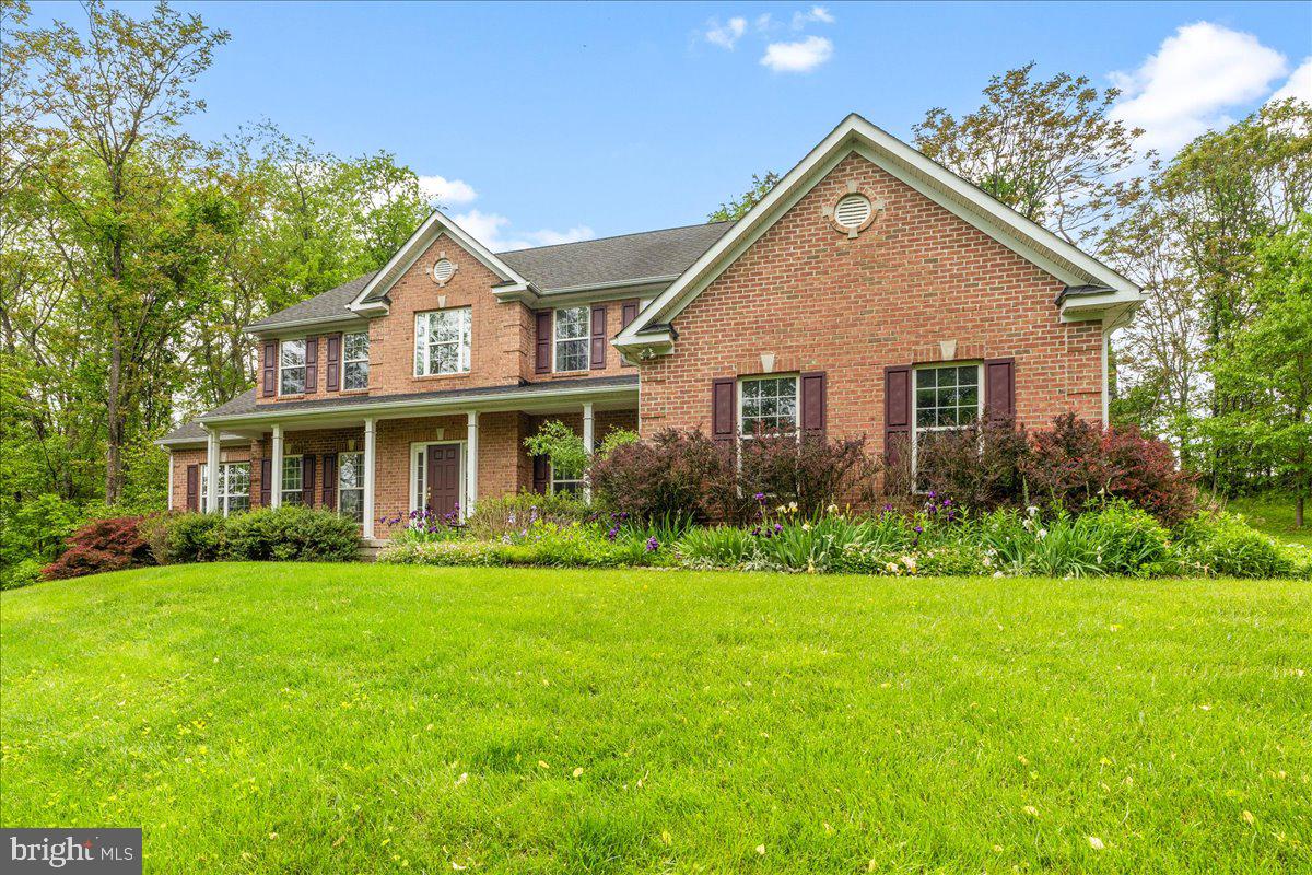 Welcome to this beautifully maintained, expansive home offering over 5,500 sq ft of living space on nearly two acres!
This stately brick-front residence is ideal for those seeking versatile living spaces and a thoughtfully designed layout. The first floor features gleaming hardwood floors and opens to a spacious office/study with custom built-ins—perfect for working from home, studying, or play. Opposite the entry, a formal dining room flows into a bright breakfast area with serene views of the surrounding trees.
Toward the back of the home, a large dining room—perfect for entertaining—connects to a chef's kitchen featuring ample cabinetry, a center island with cooktop, wall ovens, and space for casual dining. From here, step out to the screened-in porch and patio, or relax in the expansive family room complete with a cozy gas fireplace.
Adjacent to the kitchen, you'll find a generous pantry, a laundry room with garage access, a half bath, coat closet, and access to the unfinished basement. Crown molding, custom trim, and shadow boxes add a touch of elegance throughout the main and upper levels.
Upstairs, a spacious guest suite with its own full bath greets you first. The massive primary suite includes two separate seating areas, a large walk-in closet (with dual access), a spa-like bath with dual vanities, a tile shower, and a luxurious jacuzzi tub. Two additional bedrooms share a convenient Jack-and-Jill bathroom.
The 1,800 sq ft walkout basement is ready for your personal design, with rough-ins for a future bathroom and plenty of space for a home theater, game room, additional bedrooms, or entertainment areas.
Outside, an attached 3-car garage and large driveway offer ample parking—perfect for multiple vehicles or even a small business. The lot is flat, beautifully landscaped, and surrounded by mature trees, offering a sense of privacy and tranquility. Tucked away on a quiet road, yet just minutes from I-70, Myersville, Gambrill Mountain, Greenbrier State Park, and a short drive to Frederick.
With just a few personal touches, this could be your perfect forever home. Call today to schedule a private showing or to learn more!