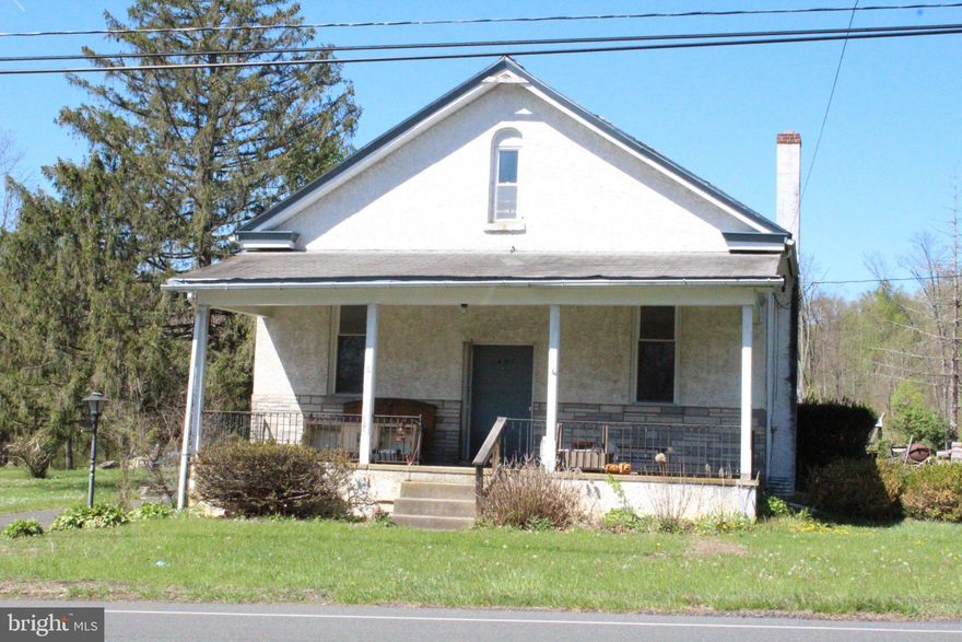 This charming 1900 farmhouse-style residence presents a unique investment opportunity with significant potential for value appreciation. Spanning 2,099 sq. ft. , the property features three bedrooms and one full bathroom, ideal for renovation and modernization to attract future tenants or buyers. The interior boasts essential features such as an attic for additional storage, a stall shower in the bathroom, and several wood stoves.  The unfinished full basement offers ample space for expansion. On the exterior, the property sits on a generous 0.87-acre lot with irregular dimensions, providing ample outdoor space for landscaping or additional structures. The presence of outbuildings, including a pavilion, an RV carport, and a second garage adds versatility for storage or workshop use. Parking is abundant with an attached garage, a detached garage, and a paved driveway that can accommodate up to seven vehicles. Located in a tranquil, semi-rural setting with street views, this property is ripe for major rehabilitation, allowing investors to capitalize on the growing demand for renovated homes in the area. With no association fees and the potential for significant rental income or resale value post-renovation, this property is a compelling choice for savvy investors looking to enhance their portfolio.