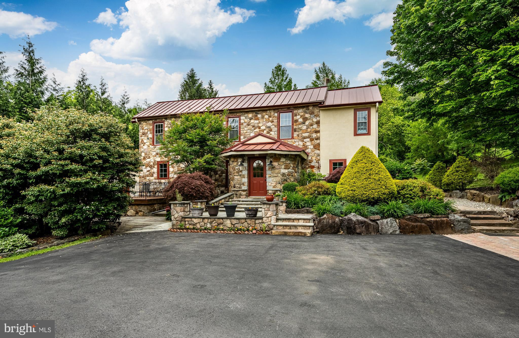 This is a fabulous c.1886 house where the creative owner changed and altered spaces to create the unique home you see today! This is not your average cookie-cutter house plus the property offers three additional living spaces! One living space is above the garage, and two are in the Barn. The extent of the home’s creative character is immediately felt with your first step into the Foyer. The room’s vaulted ceiling is sheathed in reclaimed natural mahogany and the oval shaped room features arched windows and a slate floor with beveled edges. Stone replaces a traditional chair rail and a stone arched doorway welcomes you into the adjoining Great Room and Kitchen. Here, the floors draw your attention as they are perfectly crafted with a rich combination of ash, maple, walnut and mahogany wood. The vaulted ceiling in the Great Room is beautifully sheathed in reclaimed mahogany and the light from three skylights brightens the room. The east end of the Great Room features an incredible dry laid stacked stone wall with an arched window at its center. All of the handsome Kitchen cabinets where made on site and the center island’s countertop is made from a slab of black walnut with a live edge. The kitchen counters are beautiful Italian soapstone. Thanks to several interconnecting rooms, this home is perfect for someone who loves to entertain as there is plenty of space and a wonderful flow. The Dining Room features exquisite mahogany dental crown molding and special woodworking around all of the doors. The next room is the Den which houses the staircase and a cozy gas fireplace. Finishing the main level is the Bar Room which features a wall of custom cabinets surrounding a bar with a wine cooler below. This dramatic space also features four arched windows set in a stone wall. The Powder Room is located here. A door leads to a large mahogany deck with a hot tub - a wonderful location for intimate dinner parties. Upstairs is a wonderful Primary Suite with a fabulous bathroom and walk-in closet. On this level are two additional bedrooms and an updated Hall Bathroom. The upper level hall is also home to the Washer and Dryer. For the chef in the house, there is a wonderful stone and brick pizza oven off the back terrace! Adjacent to the home is a Three Car Garage. One Garage bay has been converted into a home Gym which allows you to workout daily in your own personal gym with a state of the art infrared Sauna. Over the three car Garage is a spacious residential apartment with kitchen/great room, bedroom, and full bathroom. In what was once the Barn, then the workshop for Brandywine Cabinetry, you will now find two apartments. There are two lovely ponds on the property, one of which is stocked with bass and coy while the other has a soothing waterfall. For the young at heart, there is a great tree house. This fine property is truly the work of a creative master craftsman and represents the highest quality workmanship. Additionally, a buyer will enjoy views of the nearby Brandywine Creek. A new owner will also be proud of the fact that parts of the property were featured in a Wyeth painting. All of the home’s mechanical systems have been thoroughly updated with high-end equipment. Located in the highly sought after Unionville-Chadds Ford School District, this wonderful property also enjoys very low taxes!