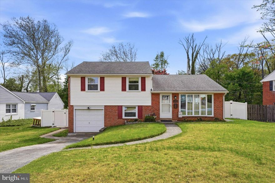 Beautifully maintained split-level home with captivating deep rear yard, nestled on a lush .35-acre lot in the heart of Springfield, offers a perfect blend of vintage charm and modern comfort. Boasting a unique four-level design, the spacious home features a thoughtful layout ideal for both daily living and entertaining. The main level welcomes you with a formal living room with bright bow window and a dining room with sliding doors 2023 to the exquisite three tier stone paver rear patio. The updated kitchen features great storage with beautiful wood cabinetry, glass backsplash, new flooring, Corian countertops and sits perfectly between the dining area, access to the back patio and both up and downstairs levels. The home’s interior is further enhanced by the original luster of hardwood flooring that flows through most of the home. The upper level features a center hallway, linen closet/laundry chute (which the owners will greatly miss ) a ceramic full bath and three tasteful bedrooms. The primary bedroom ensuite offers an attractive new ceramic bathroom. Each bedroom offer spacious closet space and two with ceiling fans. The walk-up attic off the hallway makes for excellent storage or an ideal option for future expansion. The entire lower level displays tasteful new flooring, a comfortable den/family room for extensive recreation, inside access to attached garage, a new powder room, a mud/laundry room and walk-in pantry complete this gracious level. ADDITIONALLY, this home offers a rare second lower level that is fully functionable. The high ceilings, bright lighting, new French drain/sump pump, and storage closets create the perfect space for a FOURTH Bedroom, Pool Table, Media Room or Craft Room. The oversized rear lot, vinyl privacy fence and incredible new stone patio with inlayed BBQ pit 2021, provide the ideal setting for Summer/ Fall outdoor entertainment or quiet moments simply taking in nature with your morning coffee. Additional features of this breathtaking home are: new (2) entry and screen doors, whole house generator, new water heater 2026, French drain 2024, some new windows 2019, exterior overhead and paver lighting. Attached property survey notes the property line extends beyond the fence down to the edge of the brook. Bambie and family are known to visit frequently.  308 Lewis Rd sits close to local amenities - YMCA, Springfield Public Golf Course, Tavolas, numerous favorite shopping promenades and restaurants galore to satisfy every pallet. Located in the athletically and academically acclaimed Springfield School District, this property combines calming privacy with local conveniences. Meticulously cared for and move-in ready, this home presents a unique opportunity to enjoy a spacious property to be proud of.