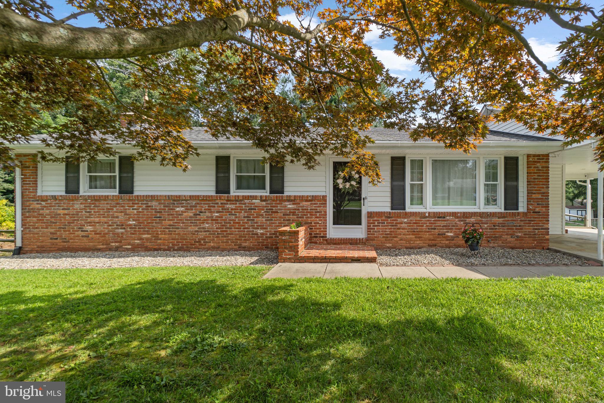 You’ll love living in Strawbridge Estates! This updated rancher is full of thoughtful upgrades and amenities. As you head up the driveway and into the carport, you’ll appreciate the covered parking, especially on rainy or snowy days. Step inside to a convenient mudroom, perfect for boots and jackets, which flows into the upgraded kitchen featuring chic white cabinetry, stainless steel appliances, granite counters, and a subway tile backsplash. Barstool seating connects the kitchen to the dining room, which opens to a screened-in porch and adjoins the living room with a large picture window overlooking the front yard. Down the hall are three spacious bedrooms and two full baths. The owner’s suite includes a private bath with upgraded tiling and mirrored closet doors. The secondary bedrooms offer ceiling fans and ample closet space. The finished lower level provides plenty of flexibility. The rec room features a built-in bar and a brick fireplace, while a partitioned area serves well as a fitness zone or home office. A spacious den, perfect as a fourth bedroom, is serviced by a half bath. The laundry room offers a walkout to the covered patio, hot tub, and fully fenced yard with a fire pit. STAMPED CONCRETE PATIO IN BACKYARD COMPLETED ON 7/22! Welcome home!