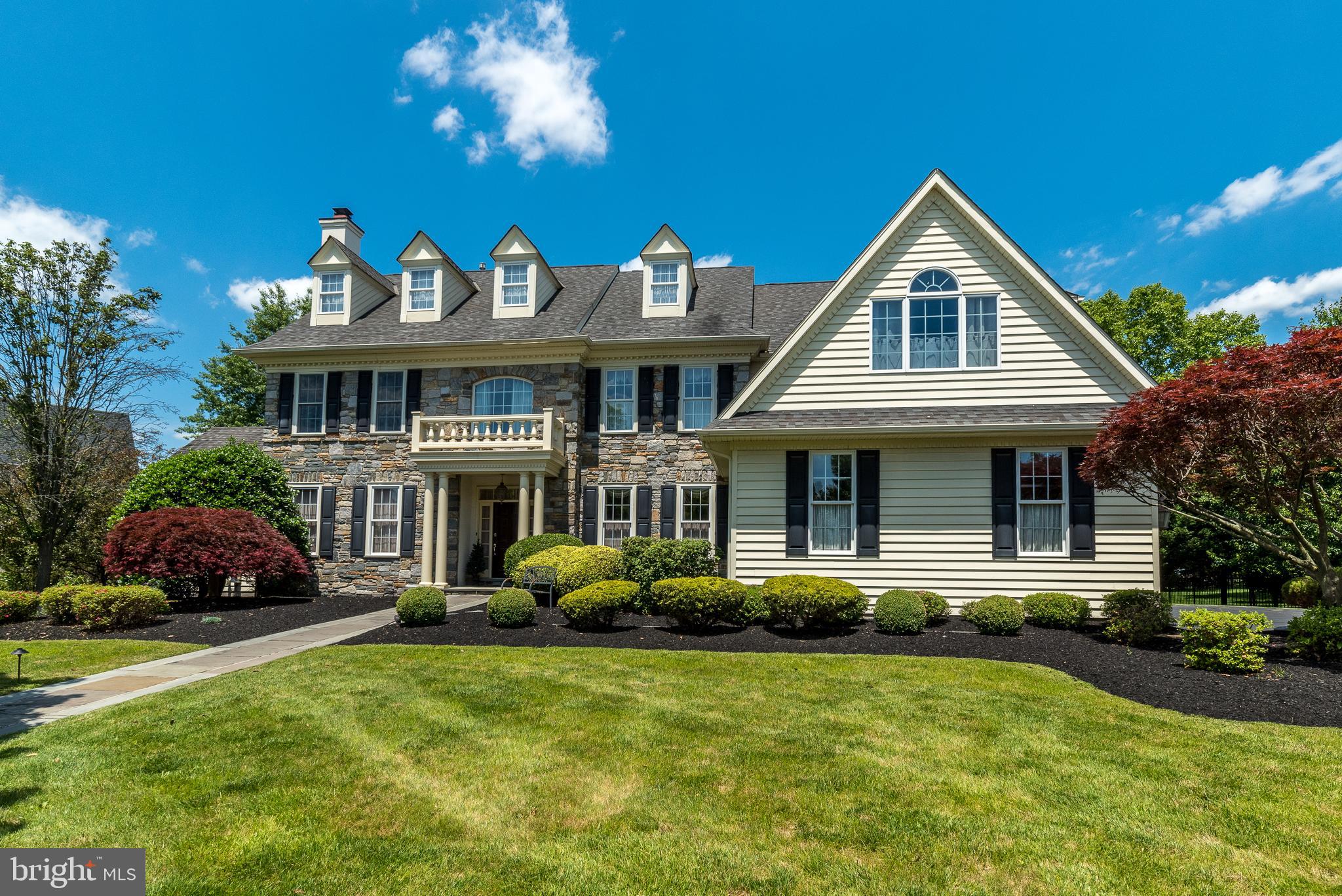 Someone once said “the best things in life are free.” No disrespect to whomever spoke those famous words, but that person clearly never reveled in the beauty of 810 Stone House Road located in Lower Gwynedd. This magnificent home, located in the highly sought-after community of Springhouse Farm, is available for the first time since it was built in 2003 as the premier model home for the development. As the model home that later won "2003 Model of the Year" in the 5-county area, no expense was spared on options or luxuries that adorn this exquisite property. The exterior is blanketed with professional landscaping including mature trees surrounding the lavish grounds of just over a half-acre. Prepare to fall in love with the sprawling interior that is appointed with handcrafted woodwork, crown molding and wainscoting throughout the entire first floor. The grand foyer showcases marble inlay in the hardwood floors and a magnificent winding staircase to the second floor. Just off the grand entrance is a formal living room with a stunning dual-side gas fireplace warming the living room and the adjacent sitting room. The breathtaking dining room will accommodate a sizable gathering and flows seamlessly through to the wet bar and the grand family room. Just off the family room you will find a chef's dream kitchen complete with custom cabinetry, granite countertops, a multi-tier island and high-end Thermador appliances including a 6-burner stove with additional gridle, double-oven and a Subzero refrigerator. Next to the kitchen is an additional eating space/kitchenette that is drenched in light from several skylights and provides smooth access to the exterior deck and patio. The first floor also offers a library, two powder rooms and a rear staircase to the 2nd floor. The rear staircase leads you to the second-floor laundry and office area. At the top of the main grand staircase, you are greeted by double doors leading to the master suite. A spacious seating area flows into the bedroom where you will find dual walk-in closets with a magnificent en-suite bathroom. This spa-like bath offers a large shower and separate Jacuzzi tub. The second floor contains four additional sizable bedrooms each sharing two full jack-and-jill-style bathrooms. Continue further to the 3rd floor where you will find a roomy bonus room that has potential to be used for nearly anything you desire. The incredible basement deserves its own showcase, with a complete movie theater ready for retreat and movie binging. The main attraction is the pub-like bar and wine cellar that is fantastic for entertaining. The lower level also features a billiard room, a full bathroom and ample storage space. This magnificent home has a three-car attached garage and a full-house generator. The stucco was fully remediated 4 years ago. This one-in-a-lifetime model home offers everything you could ever dream of and more and is nestled in a quiet neighborhood minutes from Whole Foods, Starbucks, and many restaurants and shopping destinations. Don’t miss this rare opportunity to see this masterpiece for yourself. One final fun fact: the Philadelphia Eagles used this home as the location for the Eagles Cheerleader calendar photo shoot in 2003, and a copy of the calendar is included in the sale!