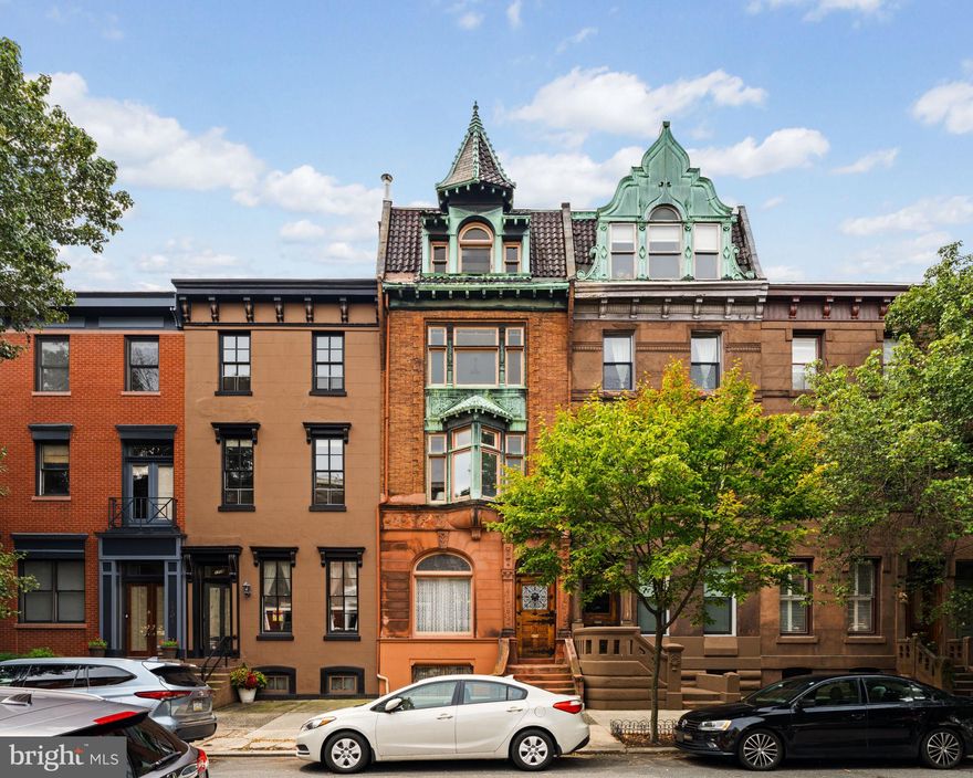 Welcome to 1708 Green Street - a captivating piece of Philadelphia’s architectural heritage, nestled in the heart of the vibrant Spring Garden neighborhood on sought-after, tree-lined, Green Street. This meticulously restored 4,000+ square foot townhome, designed by the esteemed Willis G. Hale in the late 1800s, embodies the timeless grandeur of historic design with modern amenities and a spacious floorplan. This expansive home sits 18 ft in width on a 124-foot-deep lot and features 5 bedrooms, 2 full bathrooms, and 3 half bathrooms, spanning across 4 floors of living.

Upon entering the vestibule into the living room, you'll be greeted by high ceilings accentuating the home's spacious and open feel, allowing natural light to dance across the beautiful hand-crafted tile floors. The room is anchored by the Victorian fireplace (wood burning) and gilded overmantle mirror, which are original to the home. Just past the living room is a conveniently located powder room. The formal dining room is adorned with striking woodwork, a bay of windows, and an intricate mantle, which are also part of the original build. This room also includes a walk-in coat closet with storage. The heart of the home is its expansive eat-in kitchen, which seamlessly blends classic design elements, state-of-the-art appliances, custom cabinetry, and exquisite soapstone countertops. The kitchen overlooks a large, lush, south-facing garden, which offers a private oasis in the city—a perfect setting for outdoor gatherings or quiet reflection amid the bustle of city living. The 2nd-floor family room, accessed through the main staircase or directly from the kitchen via the spiral stairs, is gracious and light-filled. Adjacent to the family room is the laundry room with a full-sized washer & dryer and a half bath. The Primary suite is located on the 2nd-floor front of the house amid the hallmark bow window on the front facade and is appointed with a hand-carved built-in wardrobe and features an en-suite dressing room & full bathroom. The 3rd floor of the home boasts 4 generously sized bedrooms, an office with built-in bookshelves, and a hall bathroom with a large single vanity, tub/shower combo, and linen closet. The 4th level is an open loft-style room, currently used as an artist's studio, with exposed beams, a skylight, a powder room, and incredible city views. Additionally, this home features a full basement that is used for storage.

This remarkable townhome is not just a residence but a piece of Philadelphia’s rich architectural tapestry, in an incredible location within blocks to favorite restaurants, Whole Foods, iconic museums, the Schuylkill River trails, and all the city conveniences you could ask for. Seller is offering one year prepaid parking at a neighborhood lot.