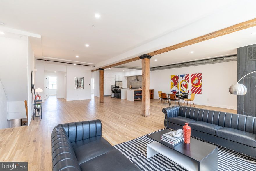 Welcome to 2218 Emerald Street, a magnificent duplex located in the vibrant neighborhood of Fishtown. Located in the heart of Philadelphia’s art scene, and close to incredible dining including : Saraya, Martha, Kalaya, Rowhouse Coffee, and Forin Café. This stunning residence offers a unique blend of modern elegance and industrial charm, providing an exceptional living experience. This converted 35-foot-wide warehouse is transformed into a stunning duplex, offering an incredible opportunity for rental income from the lower unit and enough room for your in-home office. Upon entering the building, you'll be greeted by an expansive and open floor plan, highlighted by 11ft ceilings, timber beams, and large windows that flood the space with natural light. The lower unit is a sprawling canvas of creativity, boasting a very spacious 2000+ sq ft 1 bed, 1 full bath, and an open floor plan that allows your imagination to run wild.  The double doors and exposed beams ooze industrial chic, while the brand new kitchen offers a contemporary allure. The bedroom offers a landscape view into the rear garden, finished with Pennsylvania bluestone pavers, while the front room features a Juliet balcony overlooking the street. 
Ideal for artistic inspiration and culinary exploration, this space is full of possibilities. The upper unit, spanning an impressive 4147 square feet, is a masterpiece in itself. A vast living room and dining room provide an opulent setting for gatherings and creative collaboration. Catering to the culinary enthusiast, the large chef kitchen boasts an abundance of storage complemented by a professional 8 burner Forno stove and exhaust hood and a captivating kitchen island. Imagine hosting dinner parties that blend artistic expression with gourmet experiences. A unique custom neon sign adorns the dining room area, adding a touch of whimsy and creativity that sets this space apart from the ordinary. Venture to the upper floor, and you'll discover a large secondary living space, a versatile haven that can serve as an art studio, home office, gym, or simply a spot to relax and enjoy. The primary bedroom features a large walk-in closet with a custom closet system, the en-suite primary bath becomes your private haven, where you can unwind and recharge. In addition you also have two bedrooms and a shared full bath with a custom-made penny floor. Throughout the building, natural light streams in, accentuating the extra-tall ceilings and highlighting the unique character that sets this space apart. The Sellers spared no expense and renovated the entire building in 2023 with a new roof, insulation, HVAC, hot water heaters, windows and doors, sprinkler system, electrical, and hardwood floors.  Don't miss this once-in-a-lifetime opportunity to make this converted warehouse your own. Embrace the vibrant spirit of Fishtown and let your creativity soar in this extraordinary living space.