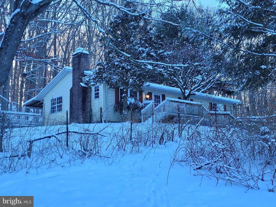 This is an estate sale.  Originally a portion of “Elizabeth’s Heaven” estate that is mentioned in documents when the parcel was separated from the adjacent estate, consists of two acres that are surrounded by beautiful contiguous parcels with a small stream at the base close to Belfast Rd. Immediately behind the house lie roughly 100 acres of preserved land that we have been told by the County cannot be developed (awaiting documented confirmation). The property is enhanced by equestrian, pastoral, and wildlife views from many windows and two exterior decks, one of which is covered, for sunrise coffee on one and cocktails at sunset on the other. The protected land that abuts the rear of this lot enhance a peaceful home for a nature-lover. A recently added detached two-car garage also includes ready access to additional significant storage for a workshop or tools, machinery, etc. The three-bedroom / one-bath home has two levels of equal 1300 sf size, the lower level of which includes a rough-in for an additional bathroom. The main level has 3 bedrooms, a bathroom, and a living, dining, and kitchen combined room, with N, S, E views, a wood-burning fireplace, hardwood floors, and decks accessible from both front and rear doors. The lower level, of equal footprint with more than adequate ceiling height and accessed via a standard staircase, offers an opportunity to almost double the finished area. The lower level rough-in for a full bath awaits the buyer with foresight and creativity to double the finished living space -- perhaps including a bedroom/bathroom with a rec room/ finished basement; its completely open clean slate awaits your vision.  This lovely property, with its beautiful surroundings that sits privately off of the main road, provides the creative buyer an opportunity to renovate the house into an enhanced home with daily equine and wildlife views if the owner so chooses. A true retreat!