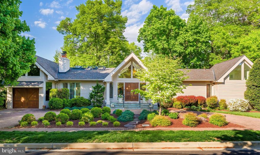 Why buy a condominium or townhouse when you can have this Chevy Chase charmer with first floor primary! Prepare to be dazzled by this beautifully updated Craftsman-style home in Chevy Chase, MD! The perfect alternative to a condo or townhome with a first floor Primary Suite with  two full bathrooms.  Beautifully landscaped grounds give you an indication of what awaits you inside. The covered entry 's double doors with glass side windows and triangular clerestory above open to the magnificent foyer with its vaulted ceiling and skylights, setting the tone for the magnificent, light-filled interior, which is ideal for large- or small­ group entertaining as well as comfortable family living. There are soaring ceilings throughout much of the main level; recessed lights; natural, reclaimed hardwood floors in many rooms; and plentiful windows offering views of the beautiful, landscaped grounds.
The main level offers an open floor plan, which is so popular in today's homes. The Living Room has a vaulted ceiling with skylights and a handsome wood-burning fireplace flanked by Open shelving and cabinets. It is adjacent to a large Dining Room with a cathedral ceiling and skylights, which in turn opens to a Solarium with cathedral ceiling, skylights, an extended window seat with windows and skylights above, and a sliding glass door to the extended Patio. The generous-sized Kitchen has plenty of space for the serious cook with plentiful white wood cabinets and a custom tile backsplash, stainless-steel appliances, a pantry closet, wet bar, and a sliding glass door to the solarium. A separate Sunroom also boasts a cathedral ceiling with skylights and opens to the Patio as well as the Garage.
The bedroom wing is where you will find the Primary Bedroom Suite. The Bedroom has two closets, attic access, a wall of windows, and sliding glass doors perfect for a future deck.
Prepare to luxuriate with two Primary Baths! The larger one features an aerated tub and an oversized tiled steam shower with built-in bench, large vanity, mirror with a hidden TV, a separate water closet, large, organized walk-in closet, and marble flooring. The second Bath, with vaulted ceiling and clerestory windows, has a marble pedestal sink with medicine cabinet above, ceramic tile shower with handheld and fixed showerheads, and a built-in niche, and ceramic tile flooring
The second Bedroom, which could also be used as a Study, has picture windows overlooking a Patio and the lovely back yard.
The finished walkout lower level features a spacious Family Room with a wood-burning fireplace and built-in cabinetry on the side. This room has wall-to-wall carpeting.
Bedroom #3 has a wall of closets, sliding glass door to the Patio and an adjacent large Storage Room. Bedroom #4 has a trey ceiling, wall-to-wall carpeting and sliding glass door to the Patio as well. A full Bath has a vanity with medicine cabinet and sconces above, a fully tiled oversized shower with Raindance head and a second hand-held shower head, and tile floor. A Laundry Room and Utility Room complete this level.
The fully finished Garage has a separate Storage Room accessed from the Garage and Patio. The circular driveway of brick pavers provides lots of extra parking.
You will love the well-designed hardscape terrace, which has plenty of room for lounging, dining, and gathering around the firepit throughout the seasons.
Add to all this a wonderful location within walking distance to shops and restaurants on Connecticut Avenue, as well as proximity to Chevy Chase Lake, the Capital Crescent Trail, and the future Purple Line for the Metro. There is easy access to downtown DC with all its many attractions, as well as Bethesda and northern Virginia. Hop on 1-495 if you need to travel out of the area from any of the three major area airports.
This is truly a home for a lifetime!