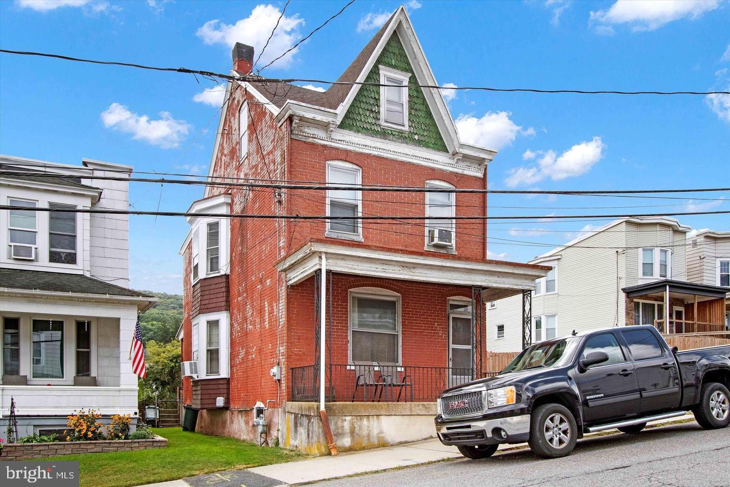 Welcome to this historic brick single full of tons of charm and character located in the desirable Yorkville section of Pottsville chock full of friendly neighbors! This home dates back to the original heyday of the city when coal was booming and owning a home like this was only for the most successful. The home welcomes you with a rocking chair front porch and a first level boasting a large eat-in kitchen, dining room (used as living room), living room (used as a work from home office) and laundry/powder room with tons of storage. All appliances (as-is) come with the home! Upstairs enjoy 3 spacious bedrooms and a full hall bathroom. The 3rd level attic has been converted to a massive 4th bedroom, perfect for teens, a gym or for more storage. The basement is unfinished but offers future potential and yet more storage. Out back find a peaceful long back yard fenced in and plenty of space at the end for off-street parking. It's time to give this gem it's next cosmetic makeover and make it your dream home. Award winning Pottsville School District and easy accress to major routes to Harrisburg, Scranton and Reading.