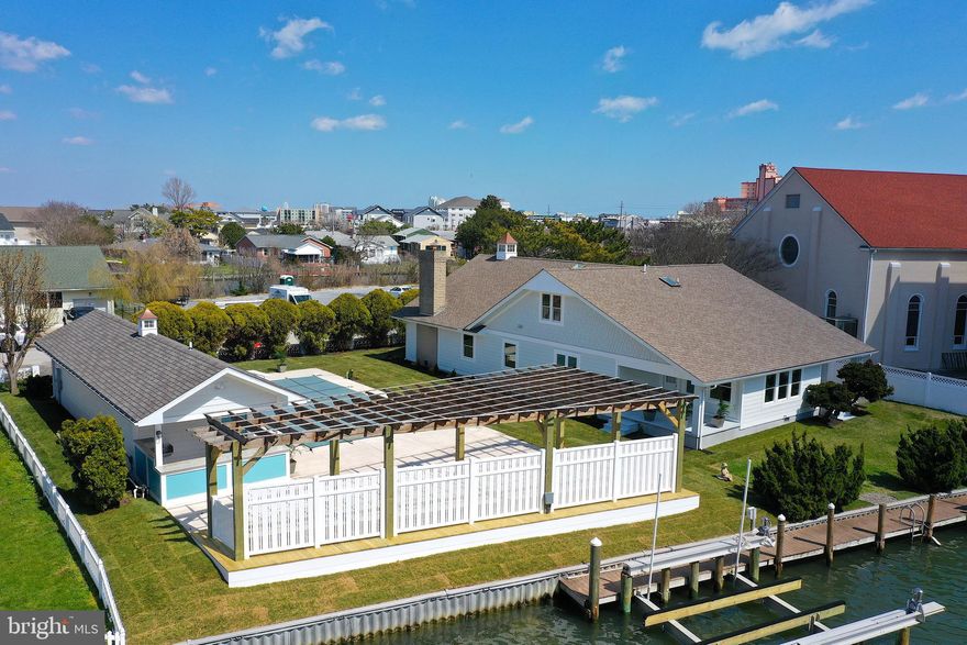 This incredible waterfront property in Downtown Ocean City combines two parcels of prime real estate into one amazing deal! Step onto the second lot and find a newly renovated pool area with a stylish pool house. Enjoy a deck for relaxation, a garage, outdoor kitchen, and two boat lifts for easy waterfront living.
Adjacent to the pool, the pool house/garage has also undergone recent renovations, boasting modern upgrades and finishes throughout. Here, you'll find a convenient full bathroom, a spacious garage, and an outdoor kitchen area perfect for dining and entertaining. Inside the main house, Six generously sized bedrooms and four full baths provide ample space for relaxation and rejuvenation. Whether you're hosting lively gatherings or enjoying quiet evenings with loved ones, this home offers the perfect blend of comfort and style.
Boating enthusiasts will delight in the convenience of not just one, but two boat lifts, ensuring easy access to the tranquil waters just beyond your doorstep. Two deep-water boat slips, meticulously designed to accommodate larger vessels with ease. Over 100 feet of bulkhead allows for no more marina fees , keep your yacht in your own backyard.  Whether you're setting sail for a day of fishing, cruising along the coast, or simply enjoying a leisurely sunset cruise, it can all start from here.
This rare downtown location just 2 blocks from our world-famous boardwalk, mere steps or a leisurely bike ride away from the vibrant pulse of Ocean City, this residence offers unparalleled access to the town's finest offerings, including coveted front-row seats to the thrilling air show from you own backyard.
Don't let this rare opportunity slip through your fingers – seize the chance to own a piece of paradise in one of Ocean City's most sought-after locations!
No HOA- NO condo fees are just another added bonus!!