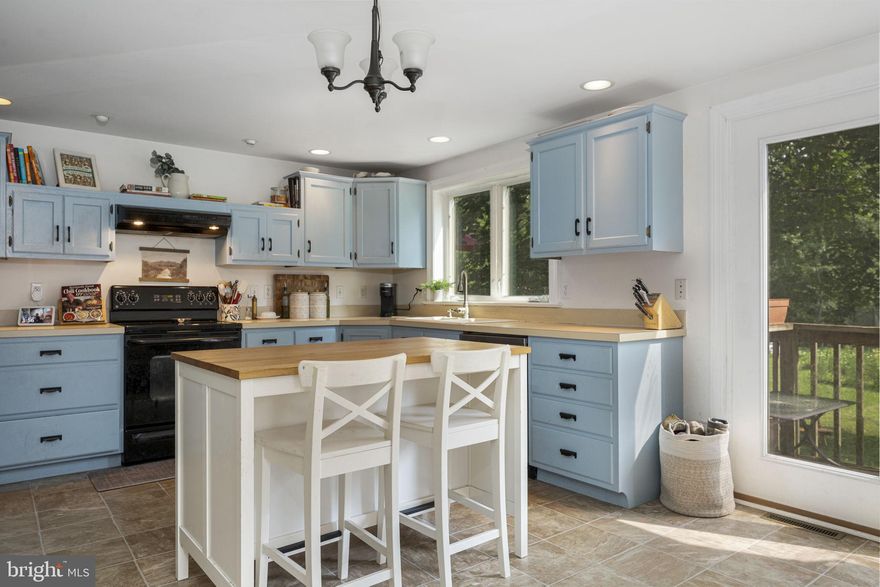 Welcome to 650 Fairview Road! This beautifully maintained 4-bedroom, 3 bath SINGLE FAMILY home blends timeless farmhouse charm with modern functionality. Nestled in a peaceful Glenmoore setting, this home greets you with a large covered front porch and delightful curb appeal. Step inside to find a bright and welcoming main level featuring beautiful hardwood flooring and tons of natural sunlight. The spacious living and dining rooms are perfect for entertaining, and the updated kitchen features cheerful blue cabinetry, a center island with seating, and direct access to the back deck and yard. A convenient main-level full bathroom and laundry area complete the first floor. Upstairs, the primary suite includes a walk-in closet and en-suite bath. Three additional bedrooms share a full hall bath. The unfinished basement offers plenty of storage or potential for future use. Enjoy relaxing on the porch or spending time in the backyard surrounded by mature trees. Updated with a new roof, this home is ready for years of worry-free living. Located in the sought-after Downingtown Area School District with easy access to parks, schools, and commuter routes, this cozy home has it all!