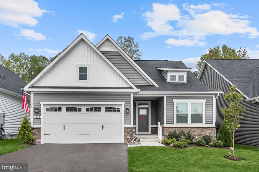 Nestled in the highly sought-after Two Rivers community, this like-new 2021-built home offers the perfect 55+ resort-style living experience. The property is a true gem, packed with numerous upgrades and high-end features, such as luxurious vinyl plank flooring, recessed lighting, 3 season sunroom, ample storage with extra shelving in each closet, and a finished lower level, making it a spacious retreat for all your needs. As you make your way inside, you'll be greeted by light-filled windows in the open concept living room, dining room, and kitchen. The kitchen is a chef's dream with white 42-inch cabinetry, roll-out shelves, undermount lighting, modern vertical tile backsplash, quartz countertops, stainless steel appliances, and a convenient pantry. A sliding glass door in the dining room provides access to a 3-season sunroom, the perfect spot for relaxation and taking in the outdoor views. The 3-season sunroom has a finished ceiling and is well insulated underneath, making this a comfortable space for enjoying the changing seasons. Unwind in the inviting living room, complete with a cozy fireplace that adds warmth and character to the space. The main level offers a generously sized primary bedroom with an en-suite bath, complete with a double vanity, tiled shower with dual shower heads and a bench, a linen closet, and a walk-in closet. Two additional bedrooms share a full bath on this level, and a well-appointed laundry room with ample shelving makes daily chores a breeze. The lower level is an entertainer's delight, with an expansive family room and an atrium door leading to stairs to the backyard. A recently renovated full lower level bath features a decadent soaking tub. A large storage room with built-in shelving ensures everything has its place. This home is also equipped with a radon mitigation system, a lawn irrigation system, solar panels, and a Nest thermostat. Step outside to the enchanting stone patio with ambient lighting, where your fenced backyard offers both a privacy wall and view of lush foliage, creating a tranquil outdoor sanctuary. An abundance of resort-style amenities are offered at Two Rivers including the clubhouse, social hall, liquor lockers, gym, library, card rooms, chef kitchen, outdoor fire pit and gathering area, raised garden plots, pickle ball, bocce, tennis courts, outdoor and indoor pool, grilling area, dog park and lake view. This is the perfect place to call home for those seeking the best in 55+ living. Property Updates: lawn irrigation system, random mitigation system, 3 season sunroom, patio with lighting, solar panels, lower level renovation, fenced backyard, closet shelving, storage rooms shelving, and more!