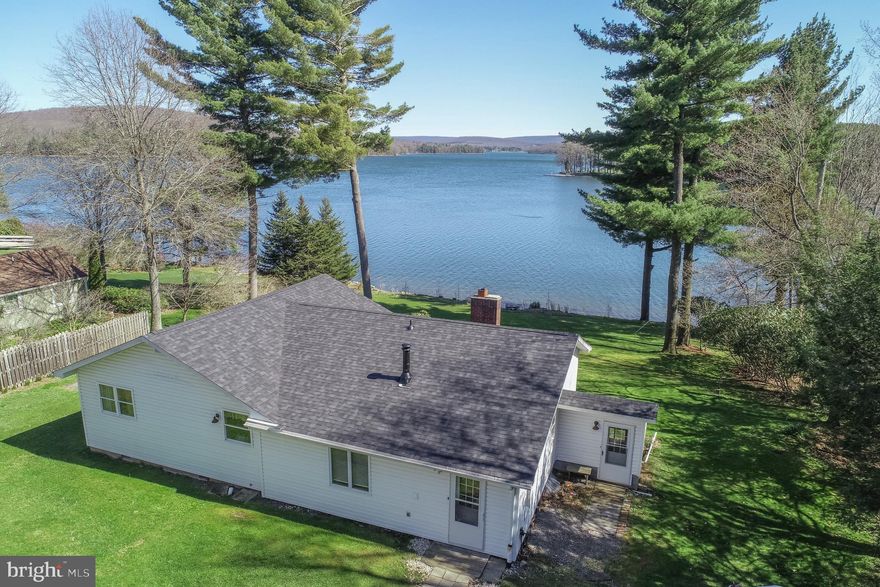 A rare opportunity to own one of Deep Creek Lake’s most exceptional lakefront settings—this property is all about the lakeside. Featuring an impressive 127 feet of premium, level lakefront, the grounds are wide, open, and beautifully parklike, offering effortless access to the water and expansive views across the entire southern portion of the lake. Positioned near the end of the highly desirable Paradise Point, the setting delivers both privacy and breathtaking panoramic scenery. The property also includes the buy-down parcel and is eligible for a private Type A dock, making it ideal for maximizing your lakefront lifestyle.
The home itself is a classic 1959 lake cottage with 3 bedrooms and 2 full baths, full of Deep Creek character and ready for its next chapter. Recent updates include a newer roof, siding, and vinyl windows. With public sewer already in place, the property offers incredible flexibility—enjoy and renovate the existing cottage or design and build your dream lakefront retreat.
Additional features include a detached 2-car garage, paved driveway, and a county-maintained, no-thru street that enhances the peaceful, low-traffic setting. With no HOA dues or restrictions, you have the freedom to create the lake property you’ve always envisioned.
Properties with this combination of level, usable lakefront, sweeping views, and building potential are increasingly hard to find—this is a true Deep Creek Lake gem.