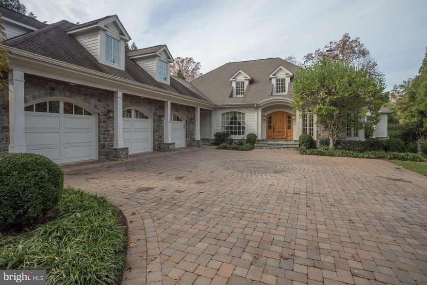 Phenomenal home with over 8,000 sq ft nestled on beautiful lot in sought after McLean neighborhood. Generous foyer greets you with warm oak flooring and detailed moulding.  There is an inviting formal living room with gas fireplace, a den with gorgeous custom built in desks and shelves, a dining room boasting two large chandeliers and a nook for server. The tremendous kitchen  features gourmet appliances, 5 burner gas range with hood, double oven, 2 dishwashers, high end cherry cabinetry and granite counters, an island with sink, a breakfast bar, large pantry with built ins, a butlers pantry, another area with built in ice maker ideal for drink service and a breakfast area looking out onto the backyard.  Off the kitchen is a cozy family room with large stone fireplace, built in solid wood shelves and tv nook and lovely coffered ceiling.  On the main level is the master bedroom retreat, featuring 2 spacious walk in closets, sanctuary master bath with heated floor, separate sink areas, whirlpool bath and oversized shower.  Upstairs you will find 3 sizable bedrooms all with en suite baths and wonderful light.  The walk out lower level includes an extensive finished area with a rec room, full kitchen, bedroom and den. There is a vast (1800 sq ft) of unfinished basement waiting for your wish list. Rounding out this exquisite home is a .62 acre lot with stone fireplace, English garden, fenced in rear yard, and room to play, not to mention the oversized 3 car garage with built in storage, an extra storage area and attic space.  Location can't be beat, just minutes to downtown McLean, Georgetown pike, 123 and the beltway, yet peaceful enough to forget you are this close to the city.   Langley High School pyramid.