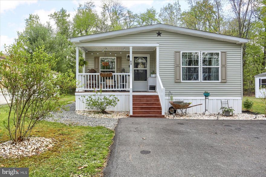 Looking for an open, newer established double-wide in Halifax Villages?  Here is the perfect home for you.  Tastefully decorated, landscape established, in a great location at edge of the Park.  This lovely home is very well maintained, with a grand open kitchen, chalk full of cabinet space with full, built-in appliance packages and large sized island perfect for cooking and entertaining with full sized table dining area off to the side.  Bedrooms are good sized, and the main bedroom has ensuite bath with soaking tub, separated shower, and walk-in closet.  Enjoy the convenient laundry room with side exterior door to the outside.  This property has a recently paved drive with ample parking, newer garden shed, and nicely planted flowers/bushes all around.  This is a great, modern affordable home ready for you!  Call today to see.