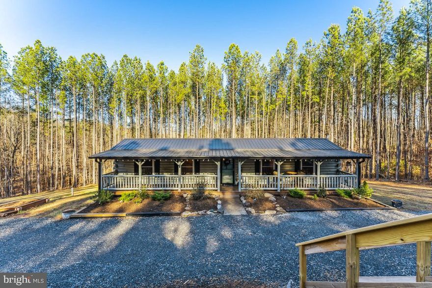 This amazing property has been priced for a quick sale and you won't believe all that you will be getting at this price!  Sellers have found their home of choice!  Retreat to this cozy oasis in the heart of Madison county.  This 2020 custom built log cabin sits on over seven acres, surrounded by tall, beautiful pines.  The property was previously two separate lots that were put together.  In addition to the acreage that the home sits on, there is a second building site with a drilled well (2020) for a second home to be built, with an approved two bedroom perc for it's own conventional septic.  The 700 sq. ft log cabin is full of warmth and so much coziness and character!  Enjoy the sound of falling rain on the metal roof or sitting on the front porch which runs the length of the home and adds an addional 300 sq. ft of outdoor living space.  There is also a 10x20 deck with stairs on the back of the home.  Inside the home, beautiful pine wood throughout, wood look, laminate flooring and ceiling beams make this home the perfect starter home, air bnb, weekend get away or a haven for the avid outdoorsman....so many options, including the perfect in-law suite in the custom built detached garage which features a large modern, black framed glass garage door for tons of natural light and overlooks the tall pine trees that frame the property, providing an additonal 600 square feet of living space.  (Seller custom built the permitted 1 bath garage since purchasing the property)  The detached garage features a kitchen, bonus room and loft, a full bath that include a large soaking tub and whiskey barrel sink.  This garage has been finished with every detail in mind, including polished concrete floors for a lasting finish.  All interior elements of the building are finished in true pine boards.  The glass garage door raises to incorporate the outdoor living space into one area.  LG minisplit HVAC system in both areas of the building.  The loft is finished with carpeting for a bonus space.  The detached garage has it's own full size refrigerator, microwave, sink and cooktop that convey with the property.  The exterior of the detached garage is ship lap style true pine siding that was milled in the Blue Ridge Mountains.  The overhanging eaves on both sides have recessed LED lighting and and an outdoor speaker system.  The detached garage exterior has also been pre-wired and plumbed for a hot tub.  For added convenience, there are three additional sheds that convey to allow for other possible uses, office space, addional washer/dryer space and finished workshop with covered side parking.  The work shop has a welding compressor outlet and numerous outlets.  The property includes cleared walking trails that lead to a camping site with fire pit and picnic table!  Established landscaping and rock gardens border the cabin and perfect for gardening.  Imagine the possibilities of this property, ALL at this great price!!  You won't be able to take it all in until you see it in person!!  It's full of character, uniqueness and charm!!  Sellers use STARLINK for wifi and have had great service!  PROFESSIONAL PHOTOS COMING OVER THE WEEKEND!   **The garage also has a 50 amp RV hookup wired on the backside of the garage with a hot/cold water spigot and prewired  for a generator with a Generac TransferSwitch.   Due to demand, active date is being moved up to 12-31-22!  All offers will be reviewed on Tuesday, January 3, 2023 at noon.  PLEASE NOTE**  THE SHED AT THE FRONT OF THE PROPERTY DOES NOT CONVEY, NOR DOES THE PLAYSET OR THE CHICKEN COOP.