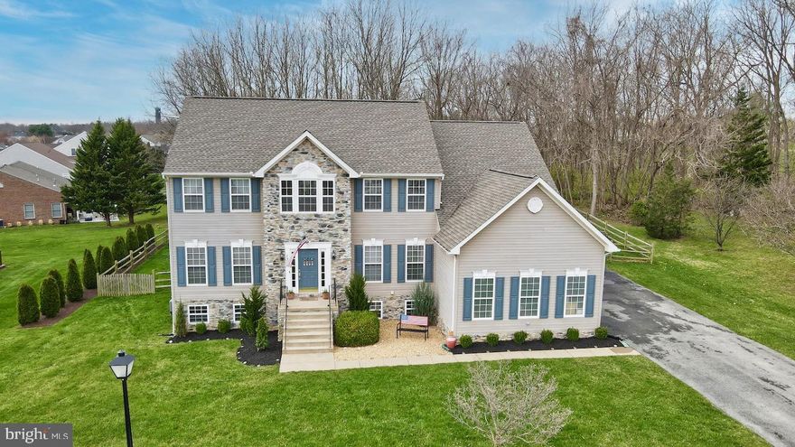 Immaculate Colonial in sought after Locust Hill Golf Course Community! This beautiful home is a short walk to the Golf Course and backs the green with a fully fenced rear yard with tree cover for added privacy! Main features on the first level include a 2 story entryway with hardwood flooring that flows into the  Custom Gourmet Kitchen with quartz counter tops, bright white cabinetry with glass and wood doors, beverage and wine fridge, island with breakfast bar seating and a gas cooktop with hidden exhaust, double wall oven, and built in microwave- High End Kitchen Aid appliance package. The kitchen features an adjoining breakfast room area which flows to the sunken Family Room offering an open layout perfect for entertaining! Additional Rooms include the Formal Dining and Living Room as well as the private Home Office and half bath. Upper level features 4 Bedrooms and 2 Baths including the Primary Owner's Suite with sitting room, cathedral ceiling, 3 sided gas fireplace, huge walk in closet and attached luxury bath. All Junior Bedrooms are very spacious and share a joint full Bathroom. Lower Level is finished with a Recreation Room and Full Bath which has walk out stairs to the fully fenced rear yard with spacious deck. 3 Car side load garage. *ROOF 2 YEARS, NEW HVAC, FIREPLACE REPLACED 2020* Community Amenities include tot lots and memberships available to the Locust Hill Golf Course!