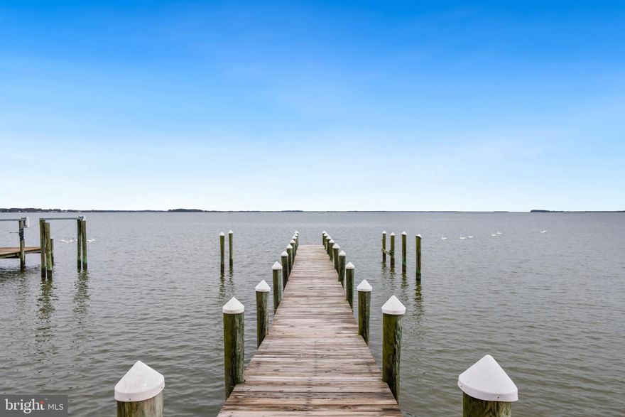 This stunning waterfront, custom built home sits ideally on a little over an acre fronting Crab Alley Bay in the prestigious Southwind community.  Home boast almost 10,000 square feet, between finished living space and additional expansion space.  An already large home offers so much more room to grow the perfect, waterfront retreat.  This gem features 6 large bedrooms and of those 4 have private baths, and walk-in closets.   Original owners designed this home to highlight 8' solid wood doors, Brazilian cherry hardwood floors, high ceilings through-out the first floor, two focal point fireplaces, second floor balcony, come see it all and in vison the possibilities this property offers.  This is truly a must-see property.   Not to mention its LOCATION.  Nestled in the Southwind community that features a clubhouse, basketball court, pickle ball court, tennis court, boat ramp, and plenty of ways to enjoy the nature.