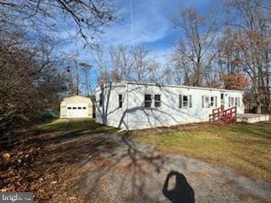 Wonderful lot close to everything. Live in Mobile home while building your new home. This property is located minutes from I-81 and convenient to Ranson/Charles Town. This property includes the land, house, oversized garage w/ lots of cabinetry, 2 extra oversized sheds. All are wired with electricity and heat/cooling.