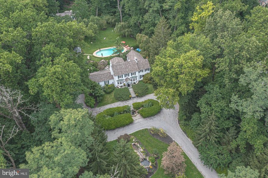 Elegant yet comfortable, this whimsical 3+acre Solebury property provides ultimate privacy and a heavenly respite. Behind the grand entrance gates graced with the name Angel Falls and flanked by specimen plantings with accents of colorful blooms is this character home with so much to offer. Beautiful, intimate spaces offering amazing views of private dining terraces, lush green gardens, and water features throughout. Gorgeous original wood flooring, substantial stone fireplaces, cozy interior areas, and elegant built-ins make this home truly a treasure. The outdoor experience is equally impressive with its welcoming circular courtyard, secret gardens, private hot tub area, in-ground pool complimented with cottage-styled pool house, greenhouse and independent carriage house with 4-car garage; ideal for offering guests a completely separate space to unwind. Peaceful living feeling whisked away yet within close proximity to New Hope and Lambertville for shopping and dining. Exemplary country living in Bucks County!