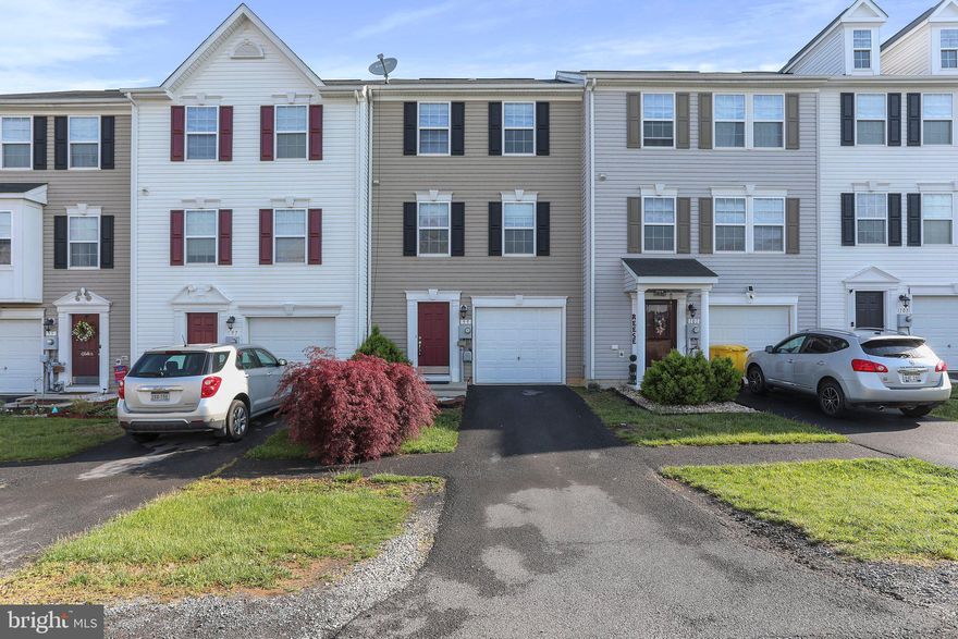 Welcome home to this three story townhome, located in the highly sought-after neighborhood of Manor Park! This spacious townhome boasts over 1300 sq ft of living space! The main level of the home includes a half bath, and features an open-concept layout, making it perfect for entertaining friends and family. The large eat-in kitchen provides a pantry, excellent cabinet space, and ample counter space, making meal prep a breeze! Upstairs, you'll find three generously sized bedrooms as well as a main full bathroom. The primary bedroom features an ensuite bathroom and a large walk-in closet. Downstairs, you will find an attached garage, and a partially finished basement with tons of storage space! No one can build behind you, which allows you to enjoy the privacy of your backyard! Don't miss this opportunity to make this your home before summer!