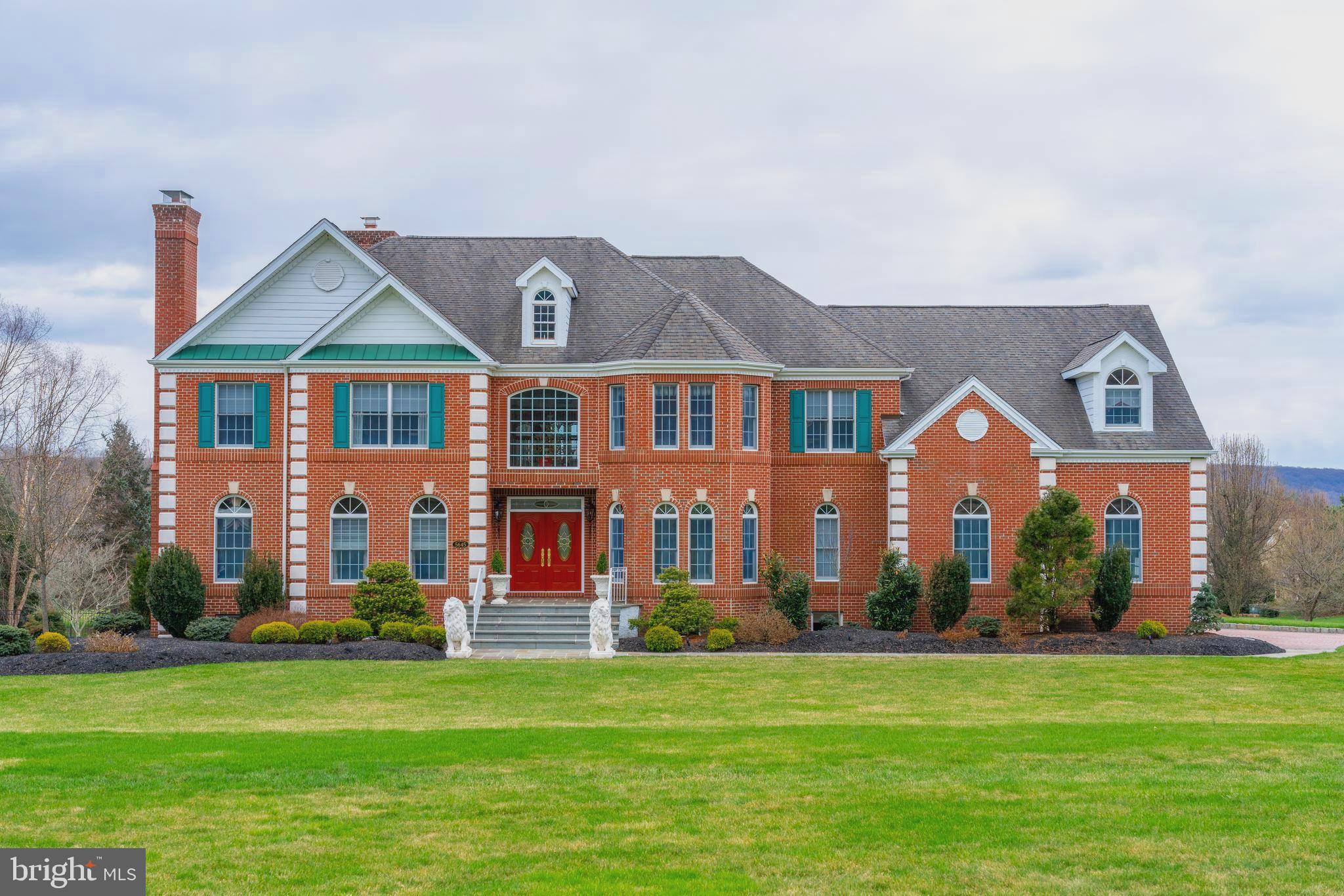 Welcome to your new home at 5645 Fox Valley Drive in beautiful Buckingham Township. Situated on 2.28 acres, this EXQUISITE ESTATE home was built in 1999 and has 5,598 sq. ft. of living space in addition to a Finished Basement. This spectacular, traditional brick front Colonial is a custom home by Deluca Builders located in Stone Ridge, a private community, in Doylestown, PA. This incredible home is an entertainer’s dream! Stunning upgrades create luxury that defines this beautiful home and its surrounding lush scenery.
When you enter the foyer, the beautiful open staircase greets you with hardwoods and custom runner to lead you to the second floor of the home. The custom kitchen has handmade custom cabinets (cherry with tiger maple and burl wood) and includes upgraded appliances …. Sub Zero refrigerator/freezer, Wolf drawer microwave, Wolf five-burner range top with downdraft, Electrolux double oven and stainless-steel dishwasher. The custom island seats four comfortably with custom chairs for extra seating. The kitchen breakfast nook features beautiful custom window treatments as well as a large round table and custom chairs. The family room is large with 18 ft. tray ceiling, handcrafted entertainment center along with a marble top and a gas fireplace. The generous size dining room includes custom window treatments and beautiful crystal chandelier. The formal living room has custom window treatments, custom moldings and beautiful French doors that lead to a private study with gas fireplace. The open and airy laundry room has Kenmore front load washer/dryer including stands and a closet for storage as well as a porcelain farm sink.
The large Master bedroom has a tray ceiling, two crystal chandeliers, custom window treatments and bedding. The spa-like master bathroom includes Toto automated toilet, custom cabinetry, radiant floor heat and Bain ultra-stand along bathtub. The master closet has custom built closet organizers. All four and ½ bathrooms in this home have been renovated and have been upgraded to include custom showers, custom millwork, custom cabinets, and more! This home also has a princess suite with newly renovated bathroom and custom bedding and window treatments.
The finished basement includes 2 storage areas, custom bar area with built in refrigerator and gorgeous custom-built ins. A wonderful place to entertaining family and guests! The walk-out lower-level leads to a magnificent inground pool and hot tub area with custom pool lighting. Stunning hardscaping and mature landscaping (with sprinkler system) make the outdoor area a gorgeous and relaxing retreat! The amazing deck is THE place to enjoy the upcoming summer days and nights. This expansive deck overlooks the-inground swimming pool and hot tub. Imagine the possibilities to relax and enjoy!
This home features gas hot water, five zone baseboard heat with three zone separate central air, water softener and security system.
The oversized 3 car garage is finished and is heated with custom millwork, tile floor and garage TEK Storage system. All windows throughout the home have U/V coating.
Just minutes from Peddlers Village and a short distance from New Hope, PA, many shops, and restaurants await your visit. The home has easy access to New York, New Jersey and Philadelphia and is located in the award winning Central Bucks School District. Schedule your appointment and tour this beautiful, breathtaking home today! Showings will begin on Thursday, April 8!