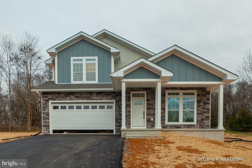 Contemporary Colonial offering a unique floorplan under construction at The Point in Shepherdstown.  Can be completed in 45 days!  Four bedrooms and three full bathrooms.  This modern design concept offers rooms that are open and ready for entertaining!  Open gourmet kitchen overlooking breakfast nook, oversized island, great room w/ fireplace.  You are welcomed from the front entry w/ open vaulted ceilings to the formal/dining living space.  There is an additional room that could be an office or a main level bedroom.  Upper level offers primary bedroom w/ walk in closet and private suite w/ soaking tub and tiled walk-in shower.  Three bedrooms and full bathroom complete the bedroom level.  Unfinished basement with a walk up to the rear private rear yard. Two car attached garage.  A new home package tucked on a semi wooded lot with beautiful mountain views awaiting from the front porch.