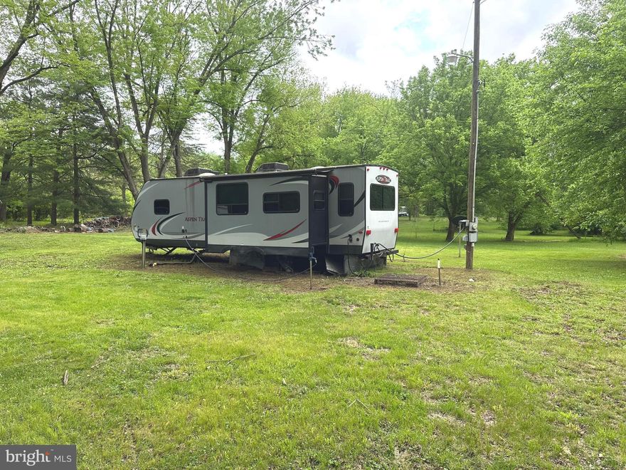 Ready. Set. Relax. Summer Starts Here! This is your chance to secure an affordable recreational getaway and kick off the season right. This package includes two level lots totaling 0.30 acres in Sportsman’s Paradise, already set up for camping and outdoor fun, plus a 2013 Dutchmen Aspen Trail camper (30 feet with two slide‑outs) that’s in place and ready to use. The property is flat, open, and low‑maintenance — no woods to clear, no hassles. You’ll enjoy full hook‑ups for up to three RVs, including a well, septic system, and three separate 50‑amp electric connections. Bring your family and friends and make it your summer base camp. Conveniently located near the Potomac River, the area offers beautiful surroundings and multiple access points to the river nearby. The sale includes both lots, the camper, and all existing utilities (well, septic, and electric), sold as‑is. Whether you’re looking for a weekend retreat or a simple, affordable spot to unwind, this property delivers. Call today and make it yours!